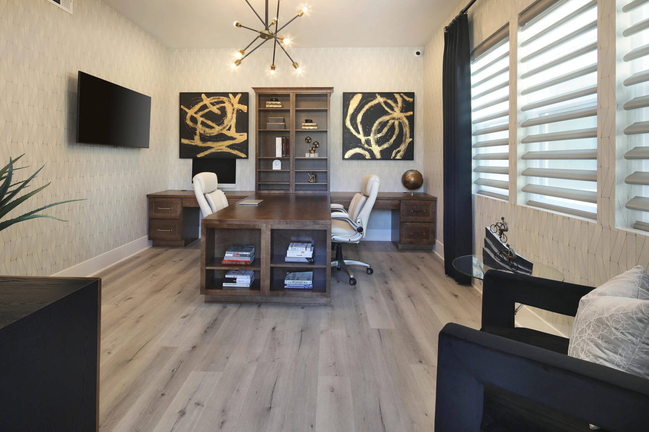 Home office with dark desk wall and matching gold artwork