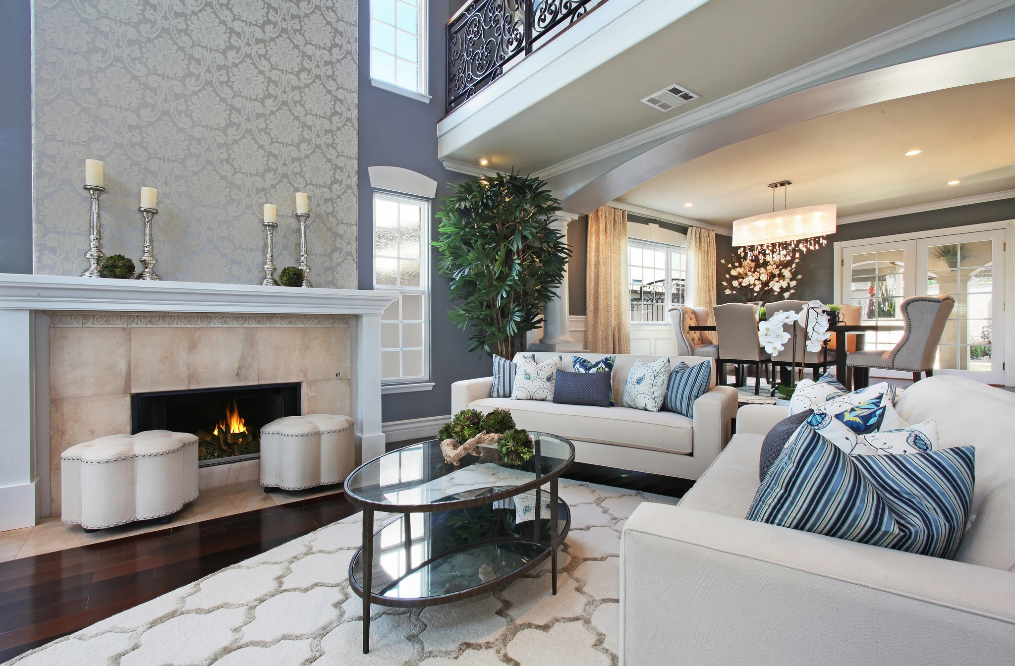 Family room fireplace with white sofa and gray patterned accent wall