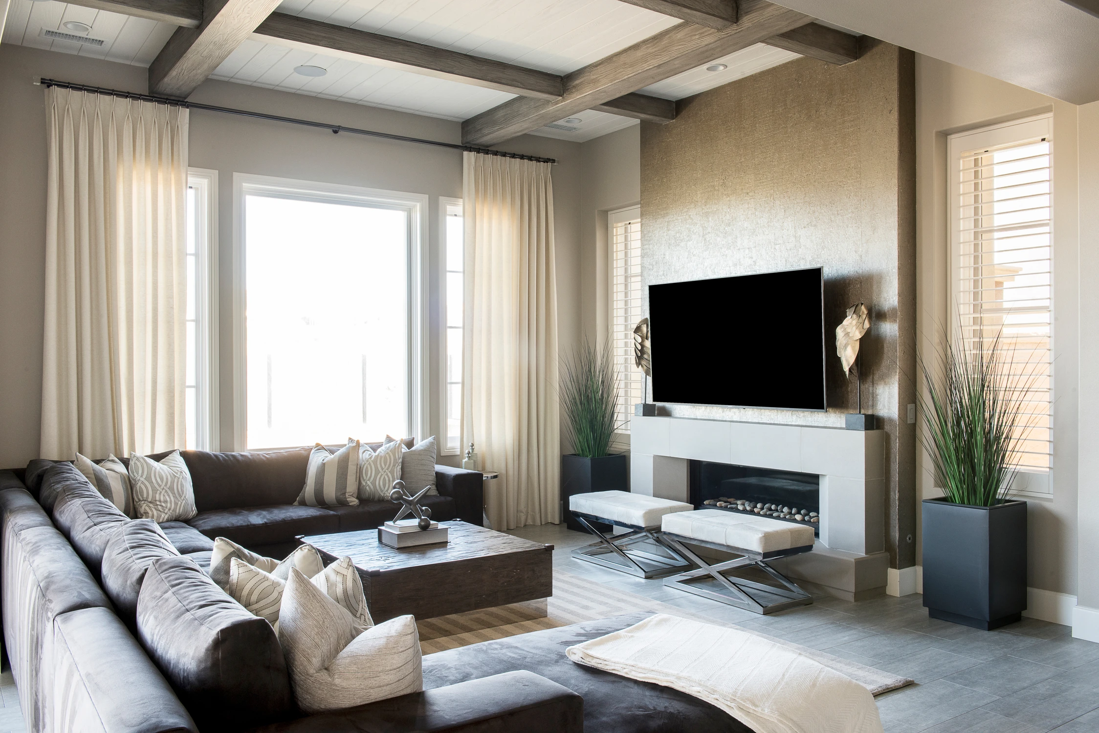 Family room with gray sectional and wall-mounted television