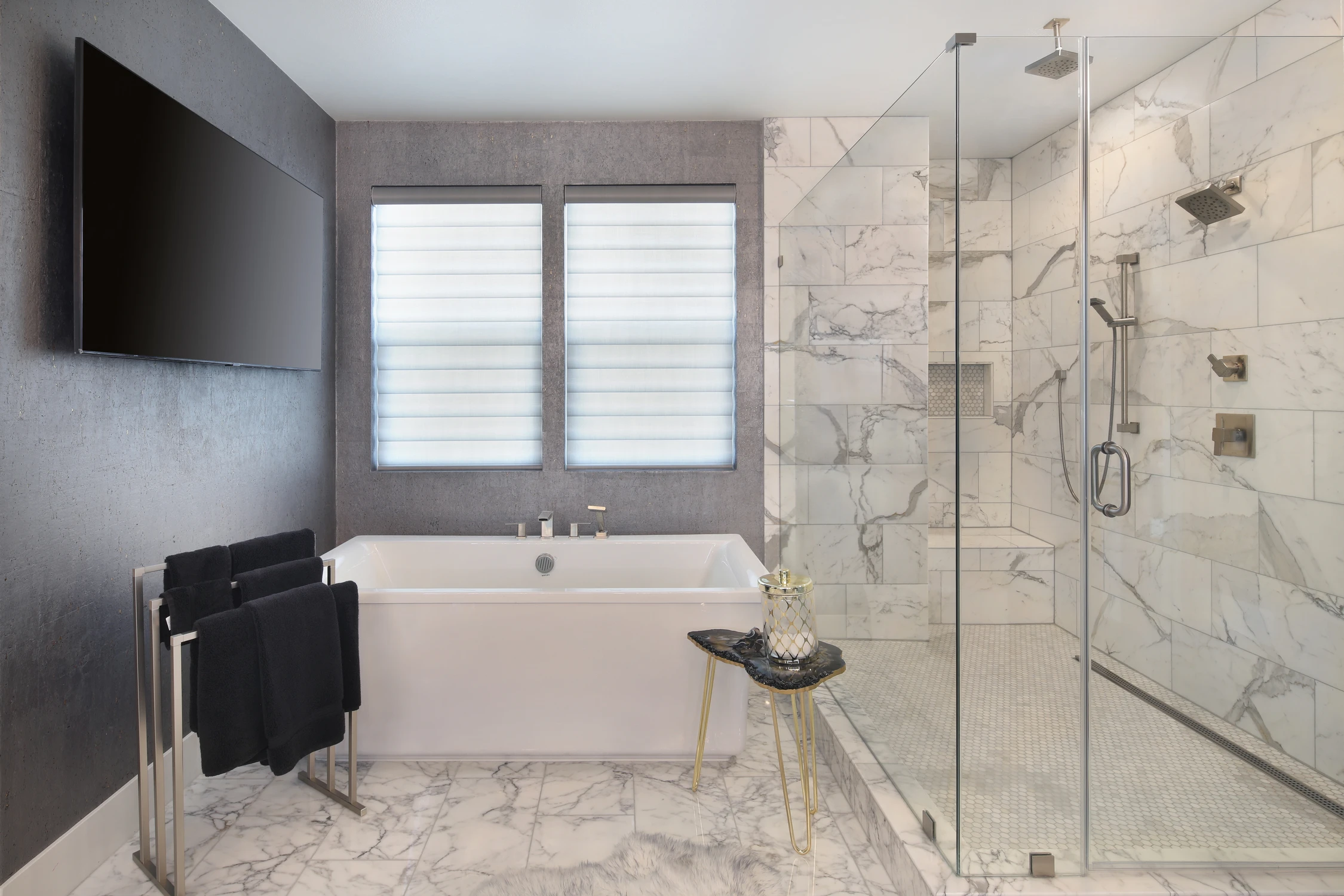 Master bathroom with freestanding tub beside a marble shower