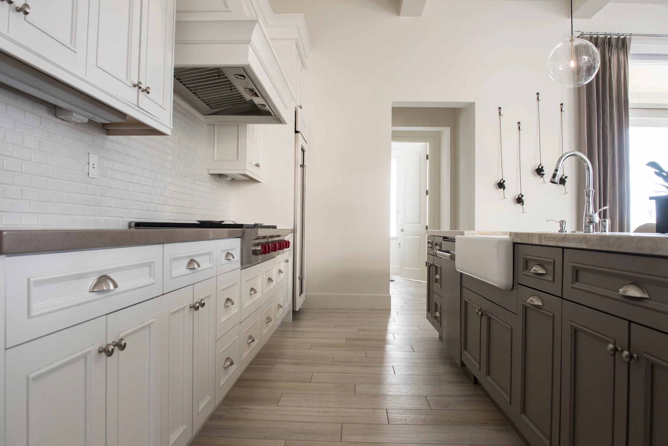 White kitchen range and gray island with farmhouse sink