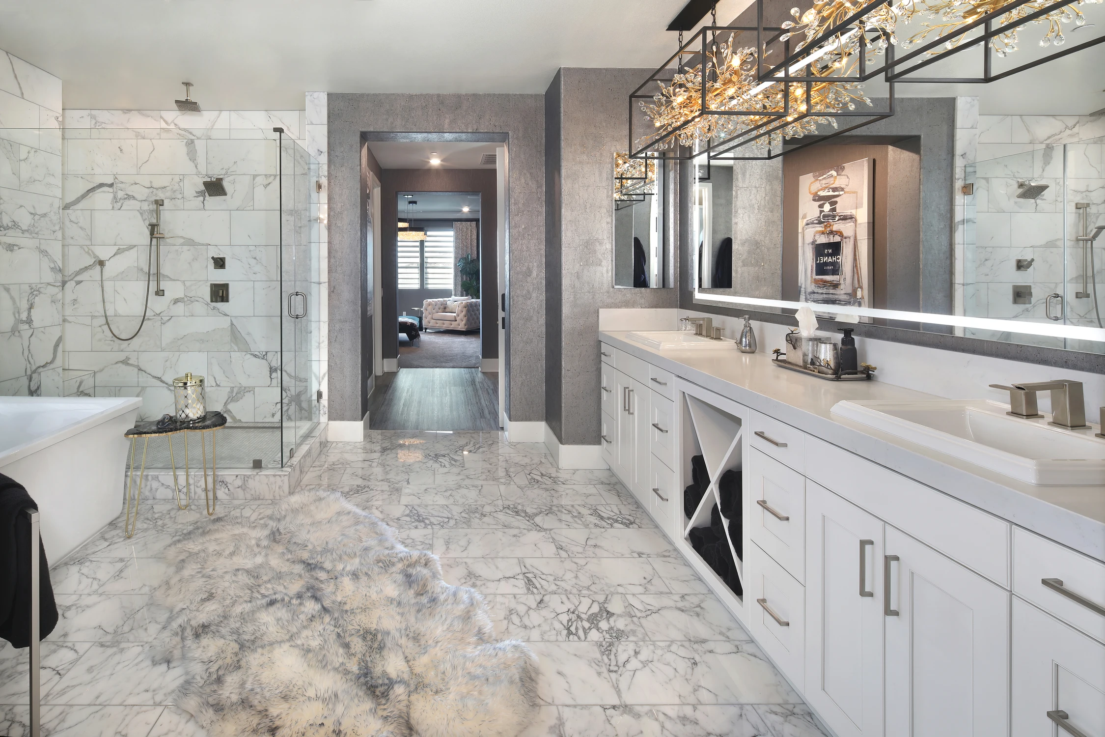 Master bathroom with freestanding tub, long vanity, and marble floor
