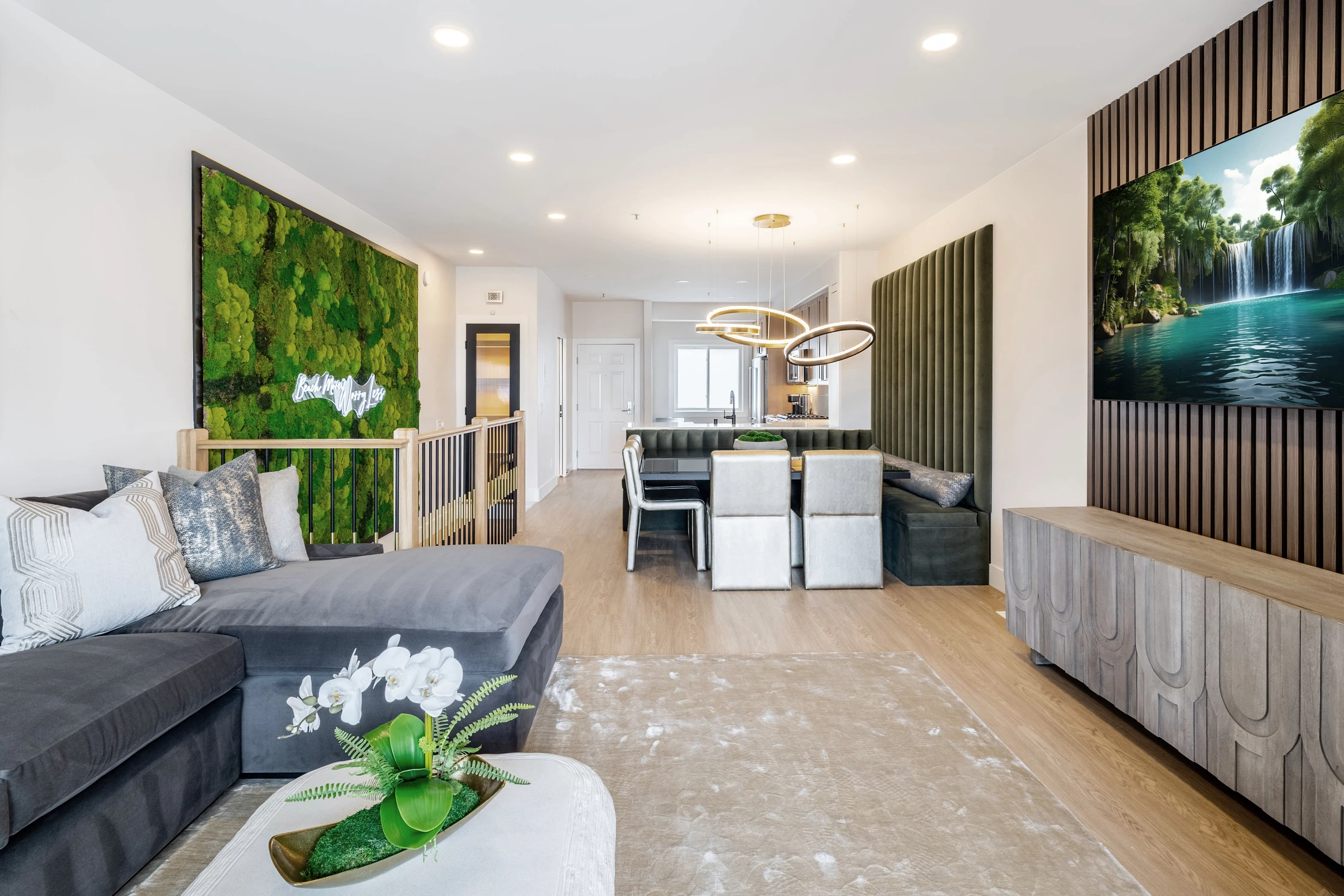 Living room with moss wall and black slatted media feature