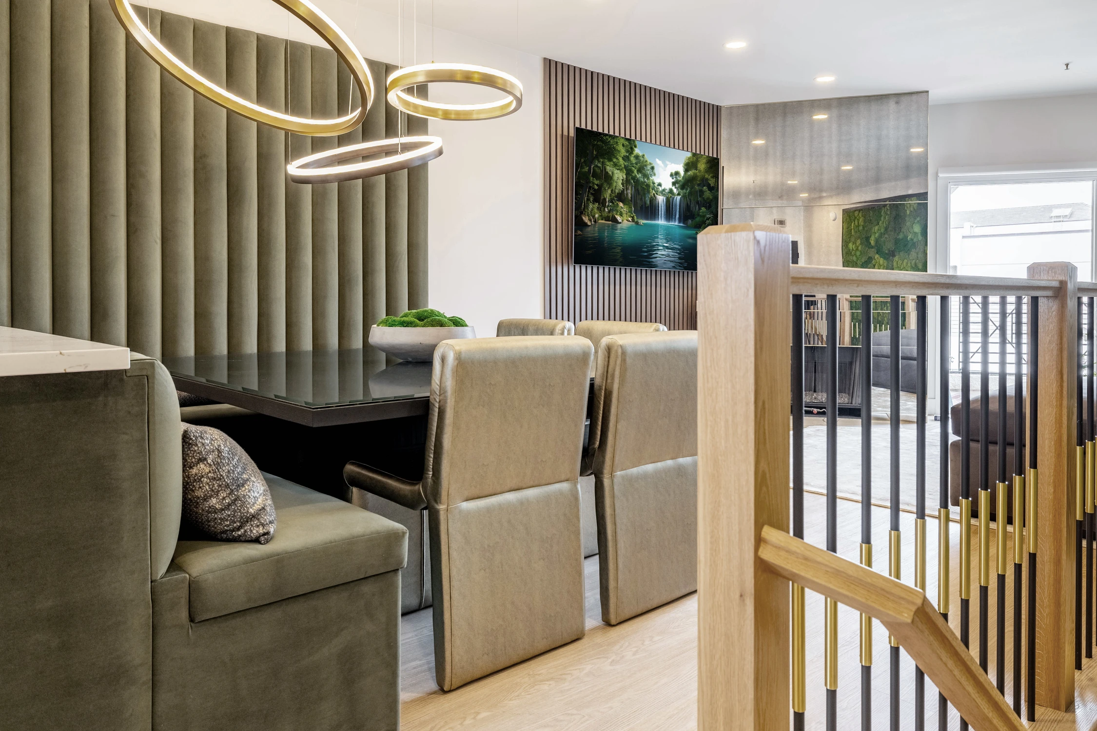Dining banquette beside black slat wall and gold pendant