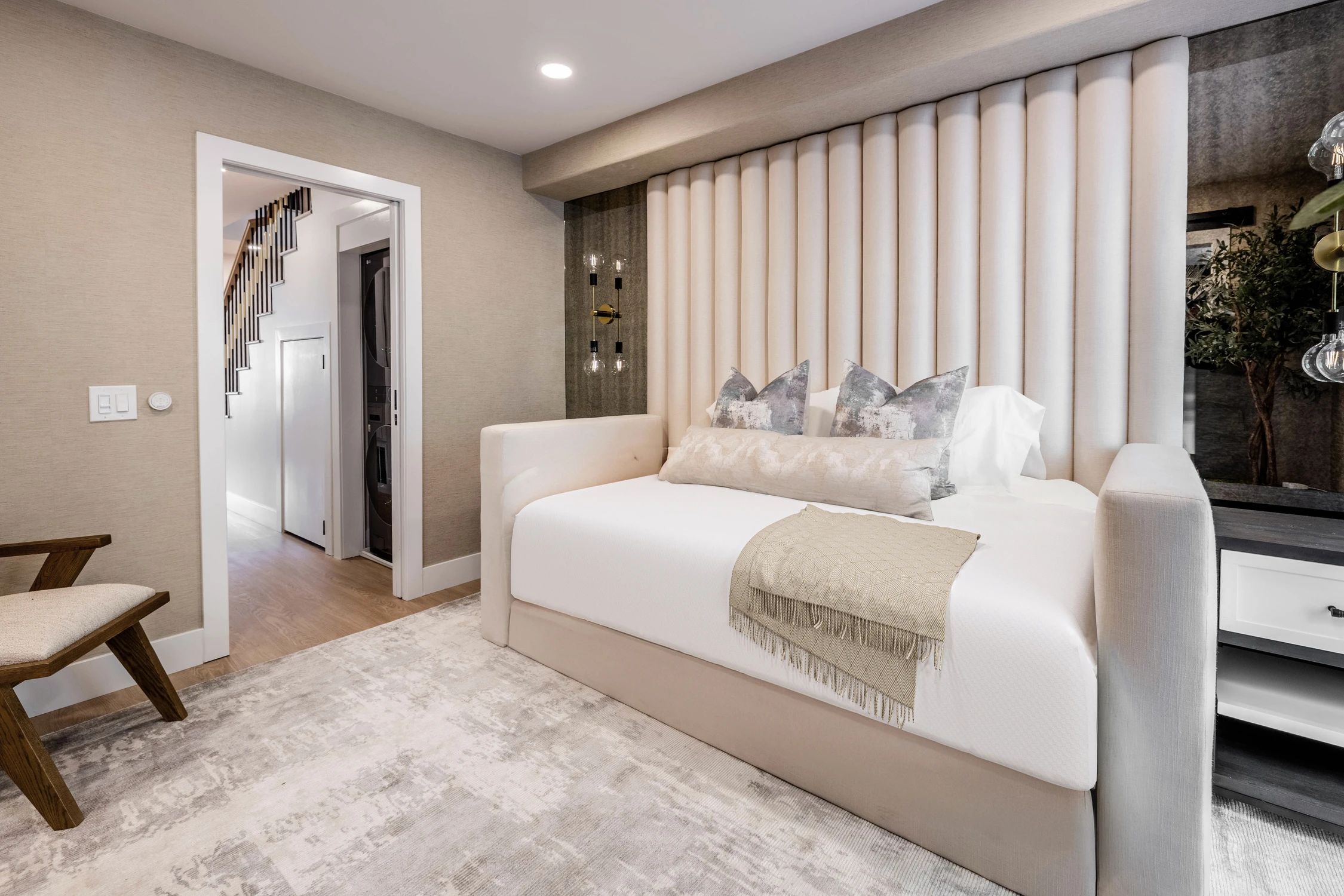 Bedroom with white upholstered bed and black accent wall