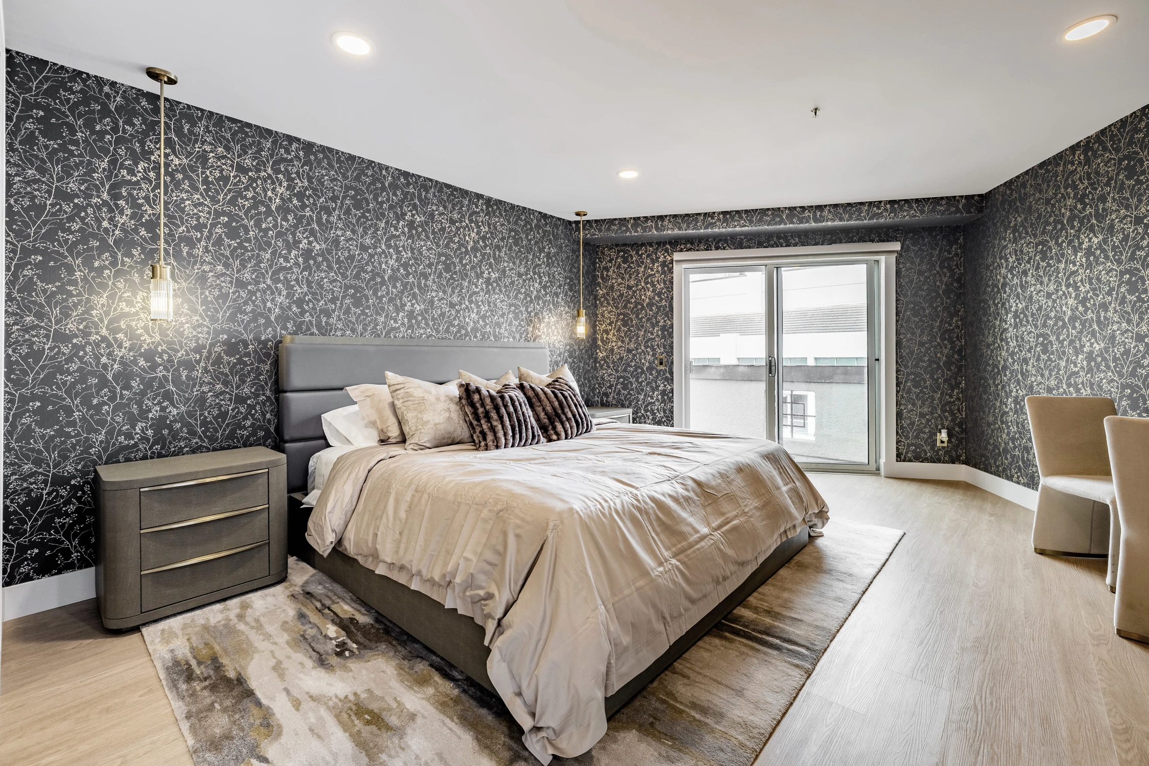 Bedroom with dark speckled wall, patterned bedding, and window