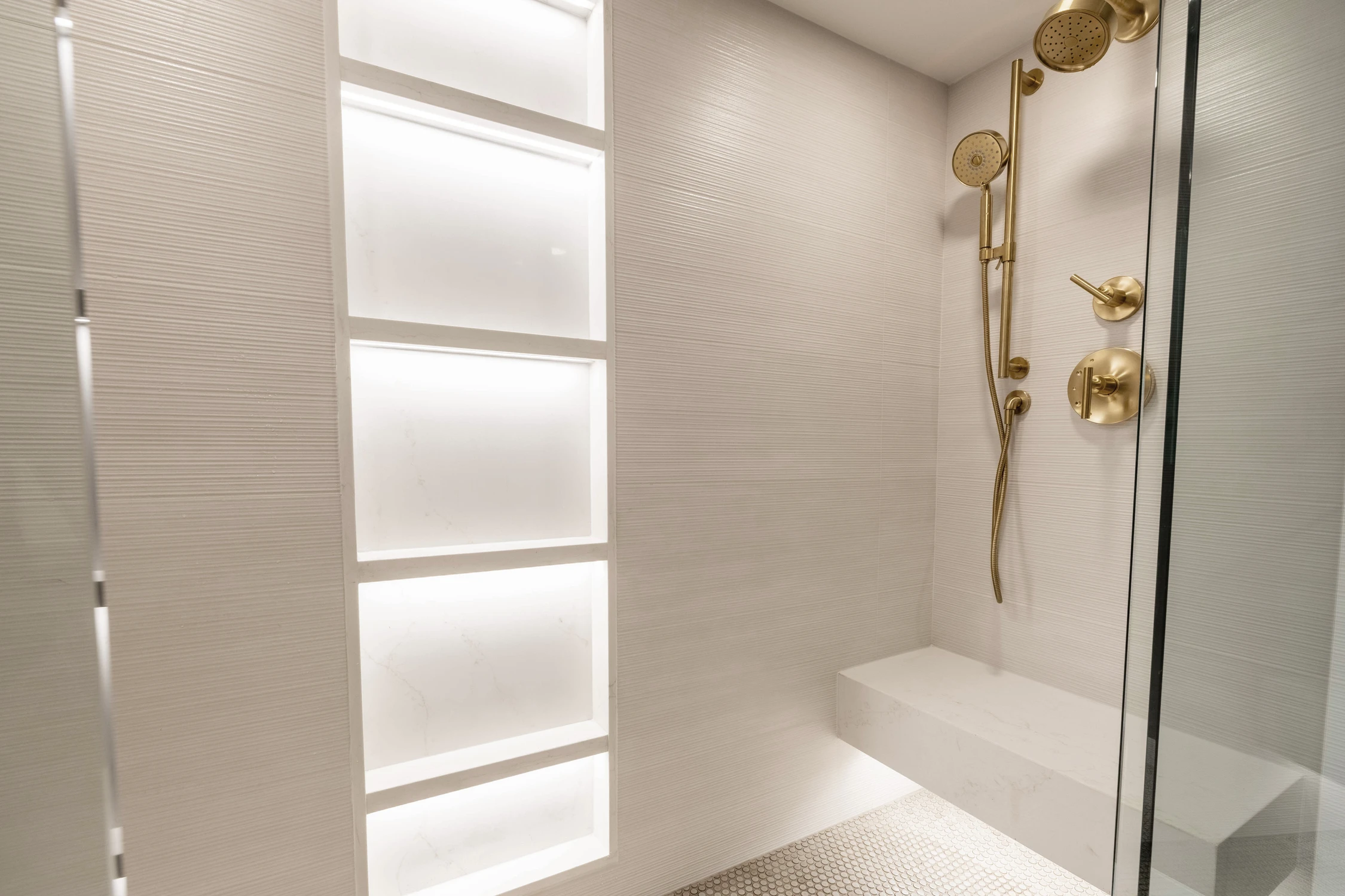 Gold shower hinges and handle on clear glass enclosure