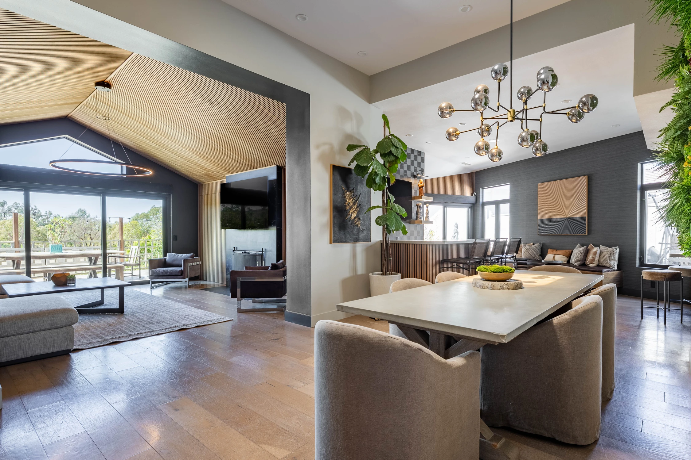 Open kitchen and living area with warm wood ceiling