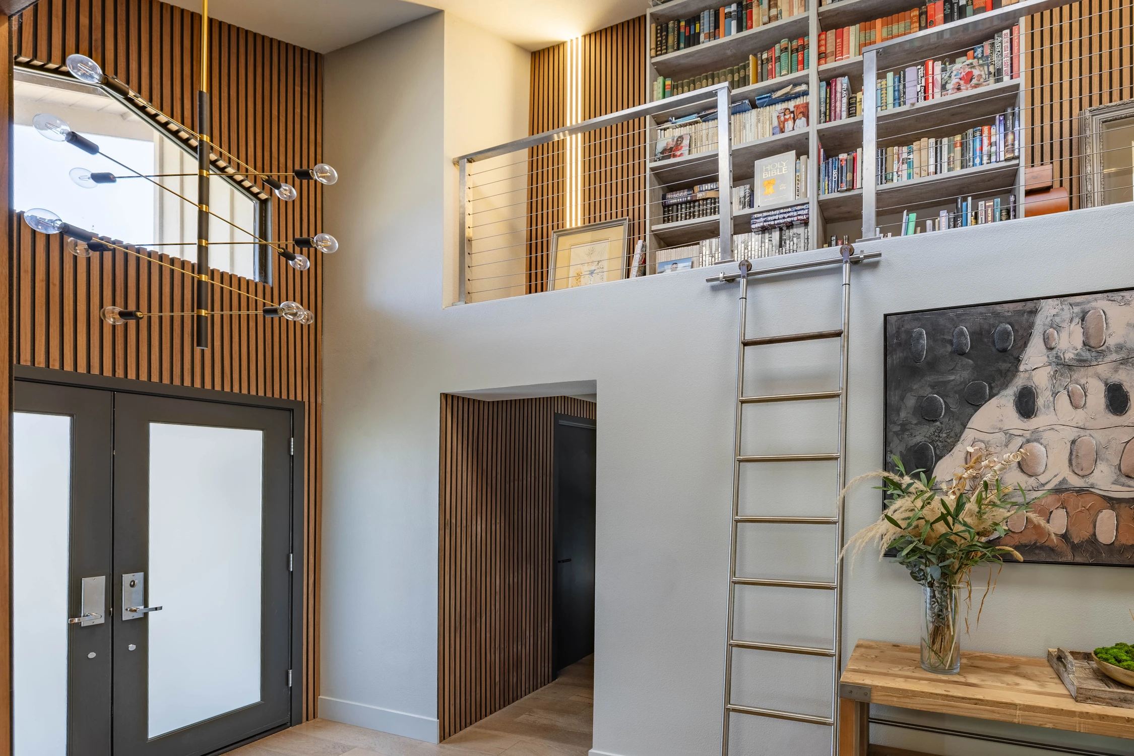 Entryway staircase beside a tall wood-slat feature wall