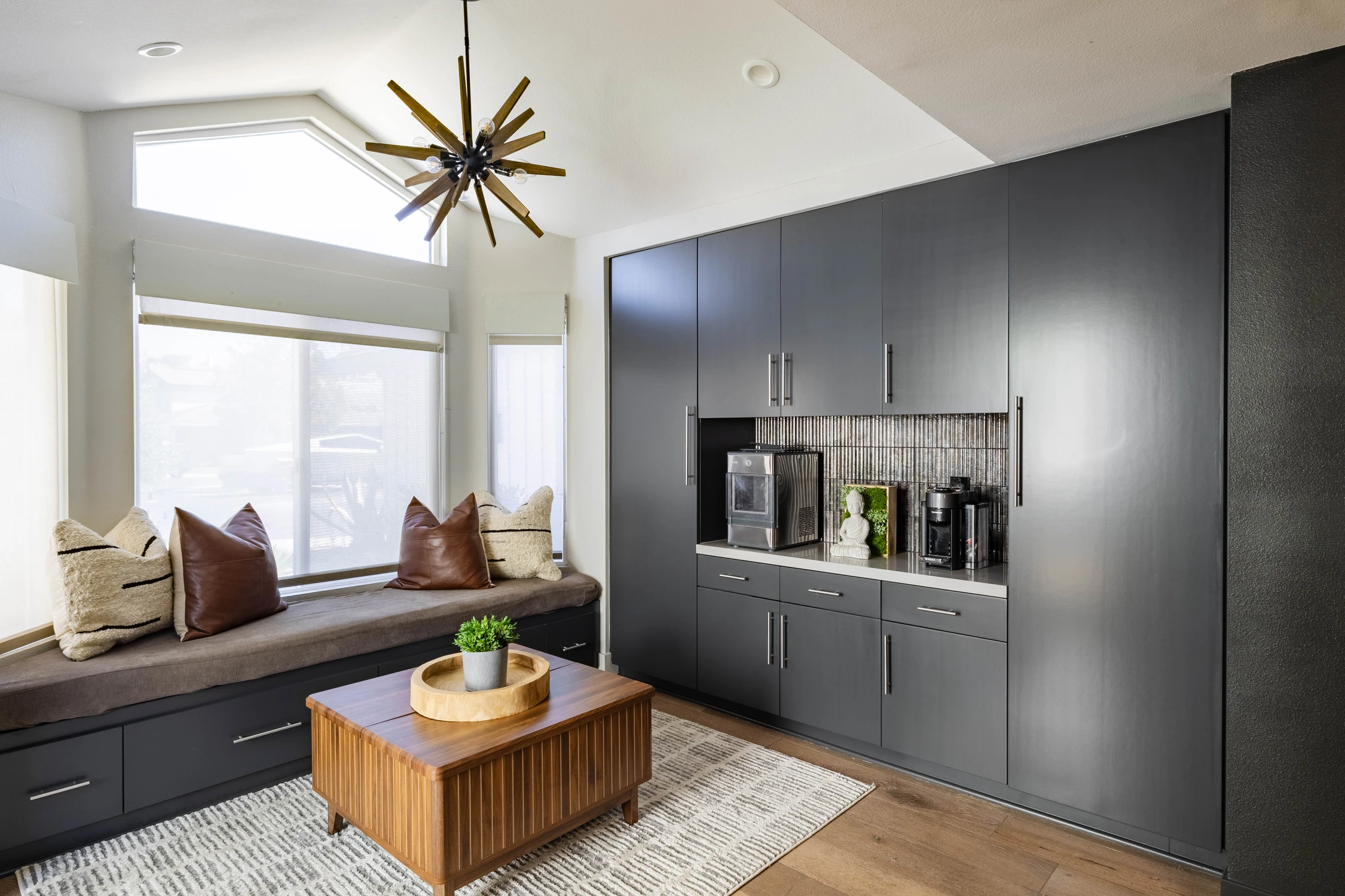 Dark built-in cabinet with window seat and wood coffee table