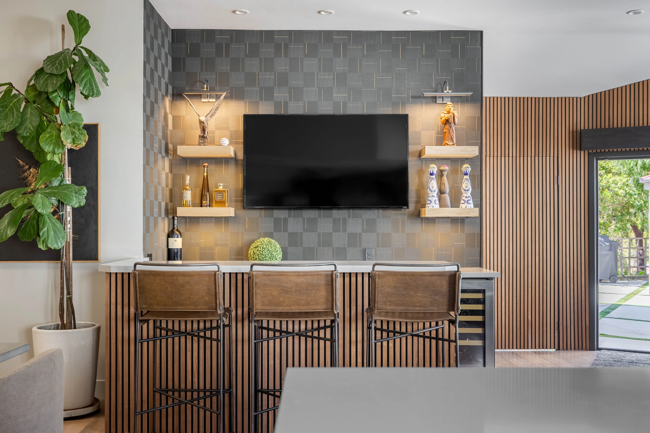 Kitchen bar with pendant lights and upholstered stools