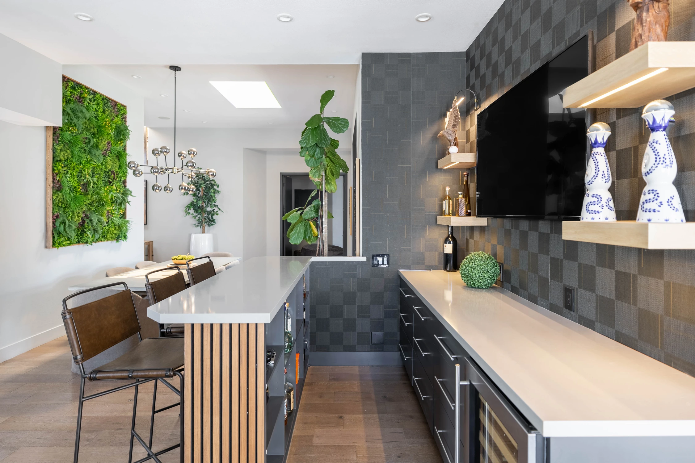 Built-in bar with textured gray tile and open shelving