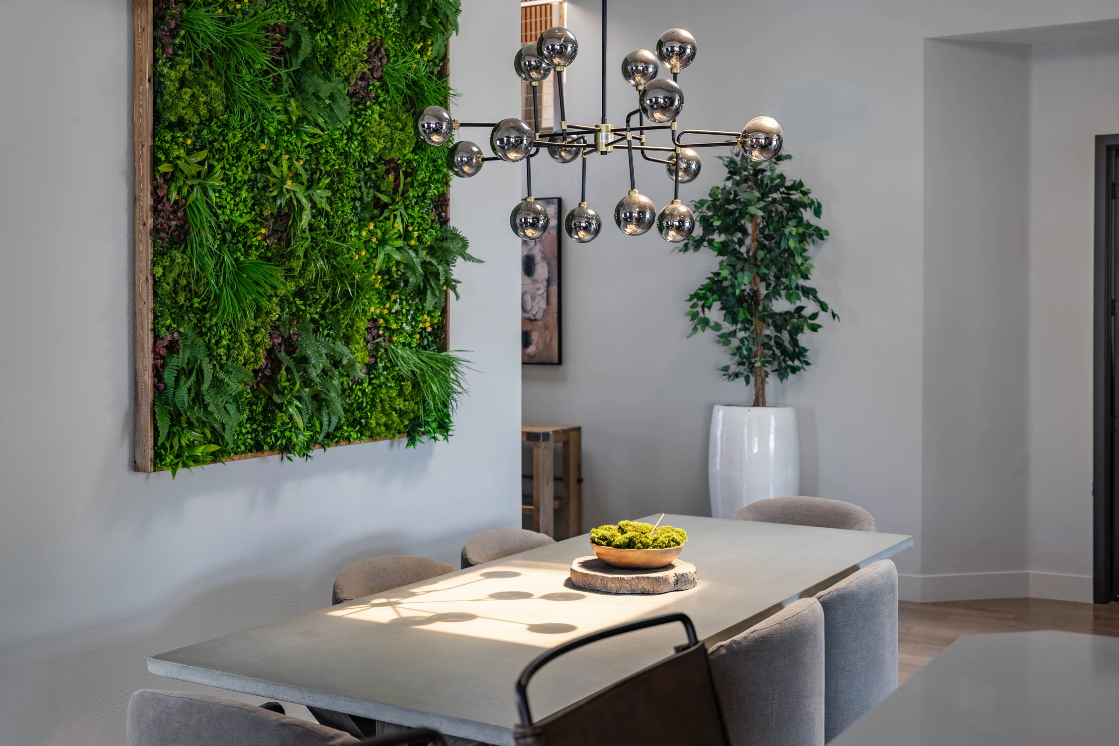 Dining area beside a planted feature wall and patterned bar tile