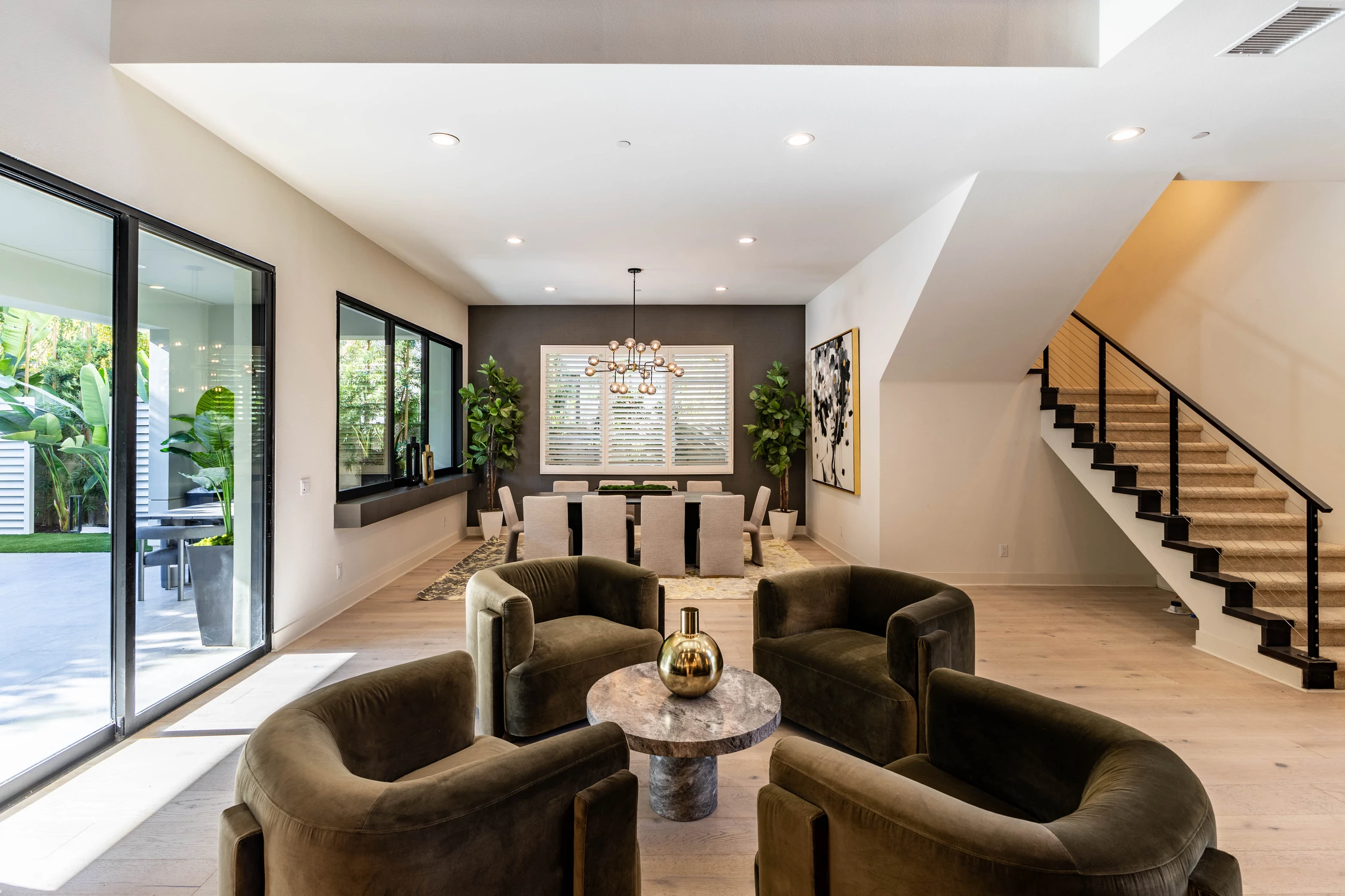 Dining and sitting areas beneath a double-height ceiling