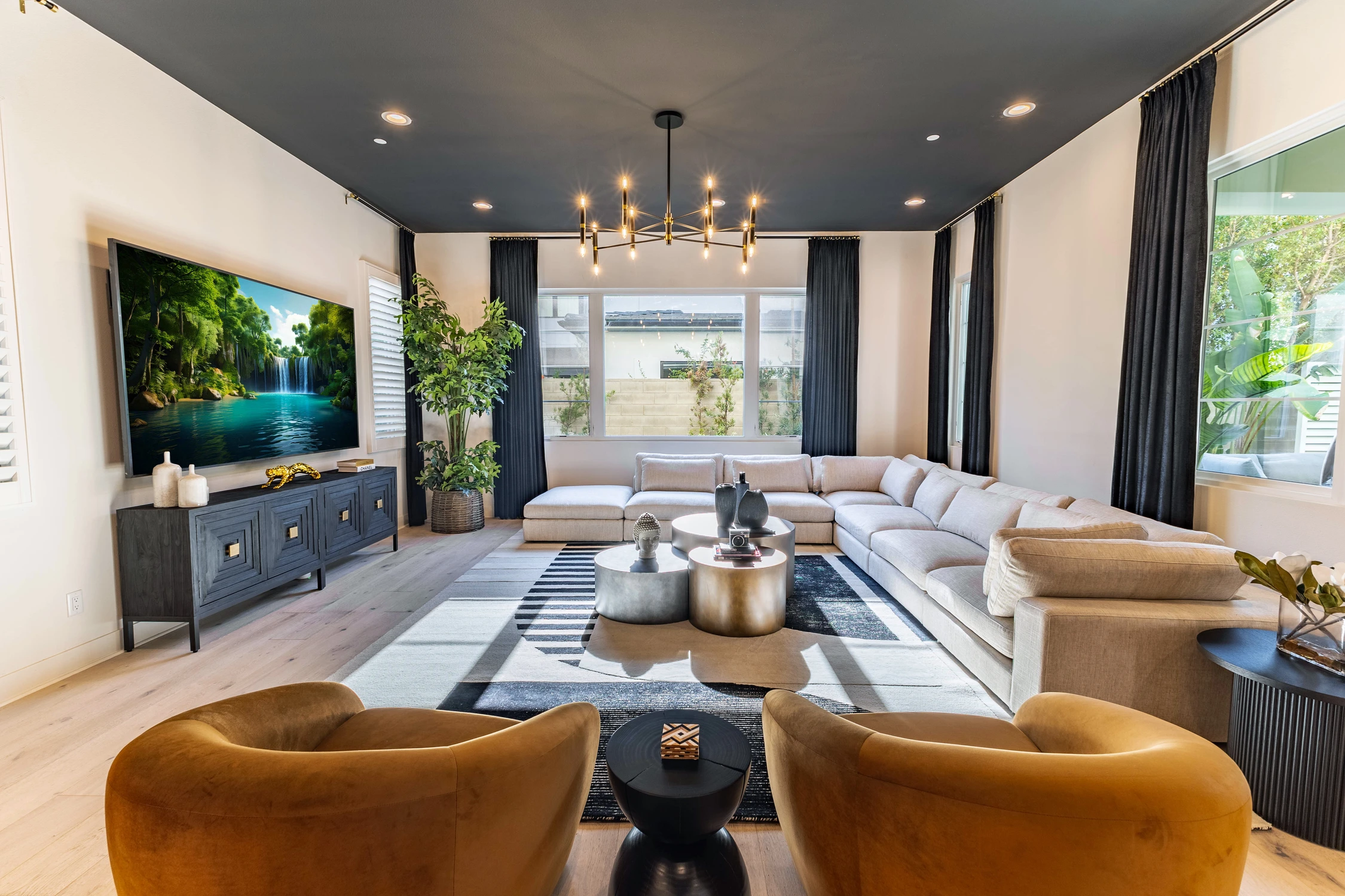 Living room with caramel chairs, light sectional, and dark media console