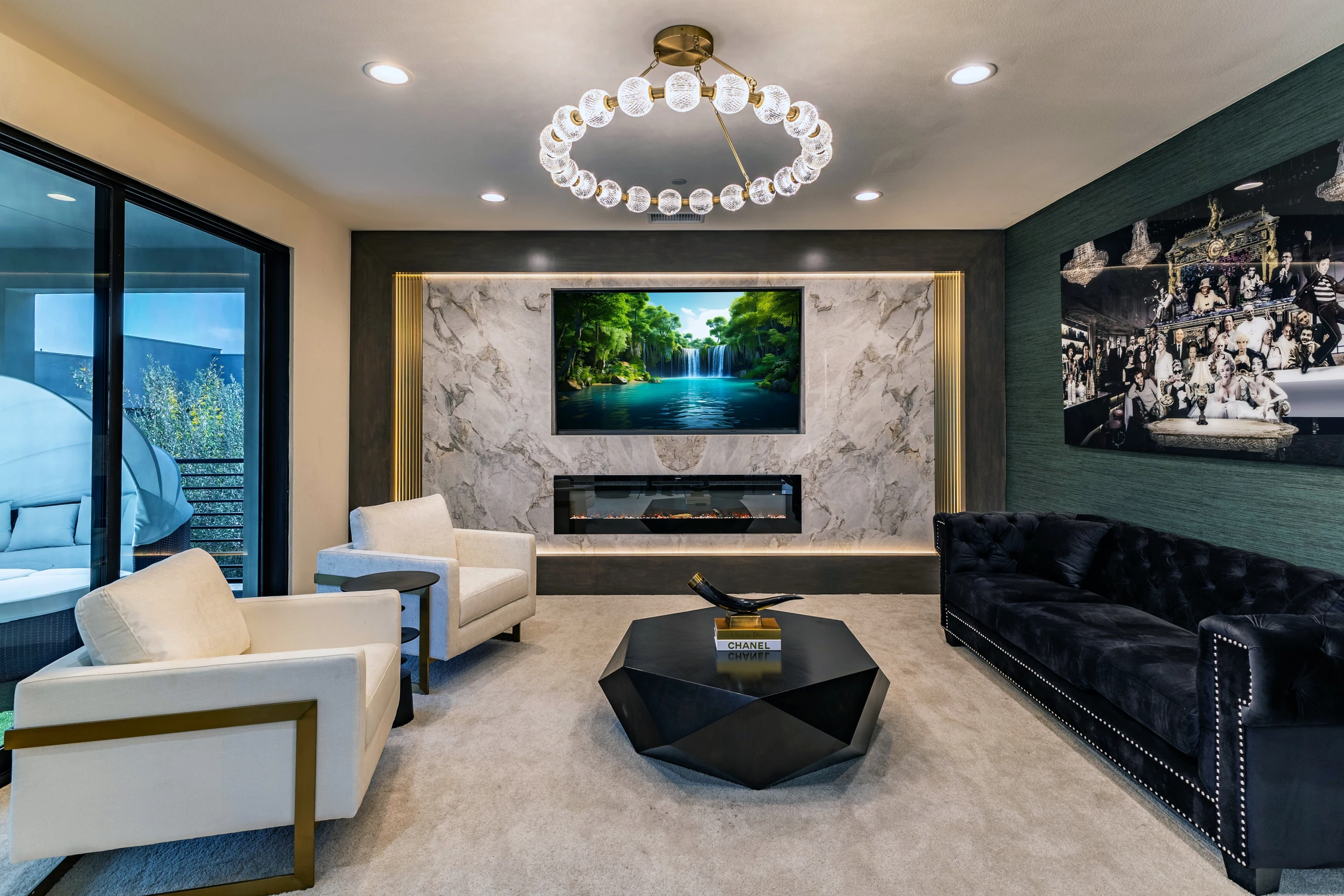 Upper-level sitting room with marble fireplace, white chairs, and black sofa