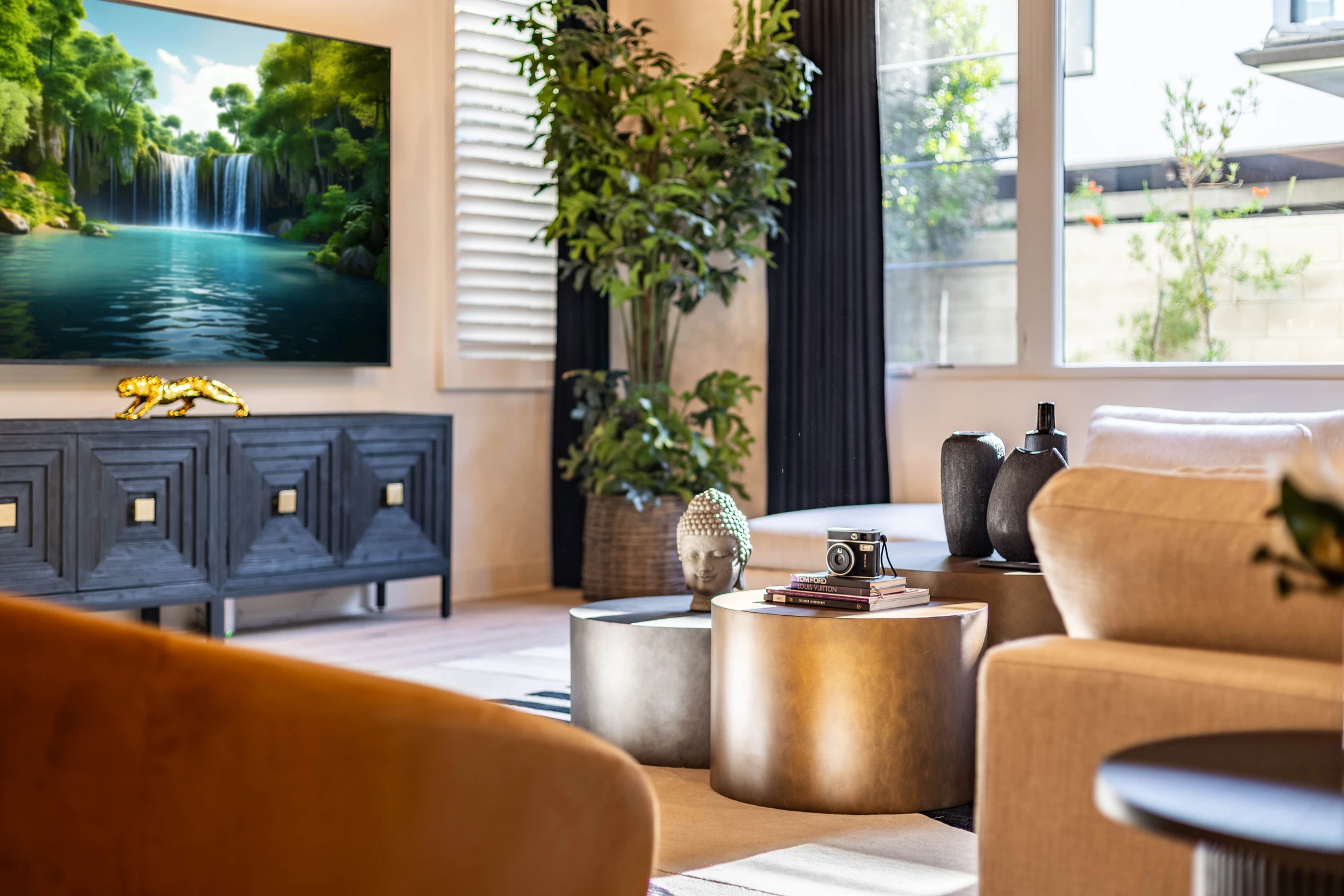 Living room with caramel chair, light sectional, and dark media console