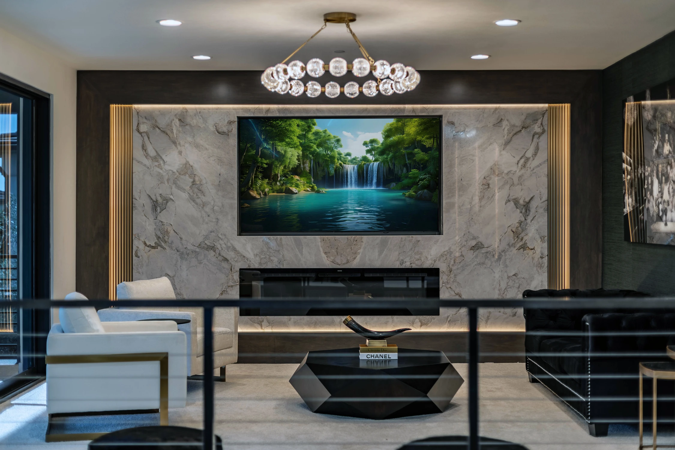 Upper-level sitting room with marble fireplace, white chairs, and black sofa