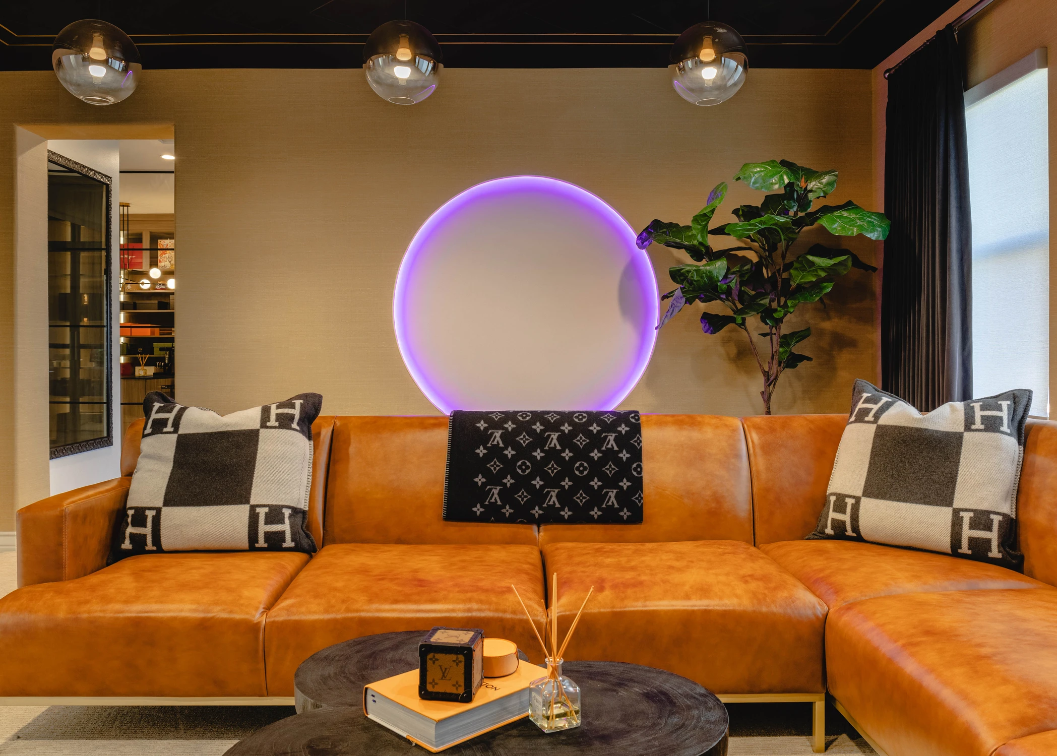 Orange leather sectional with violet backlit wall circle