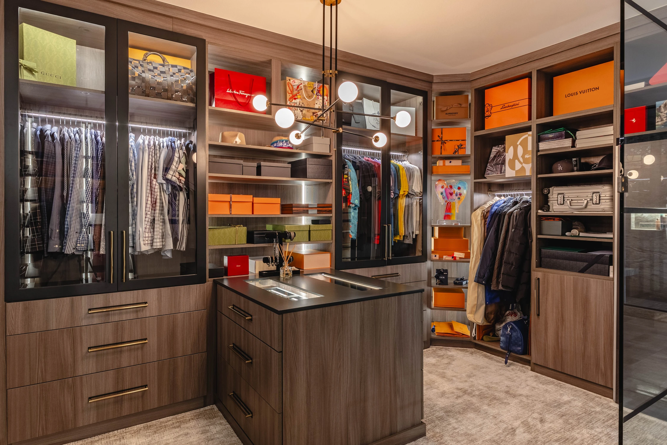 Walk-in closet with glass-front wardrobes and central island