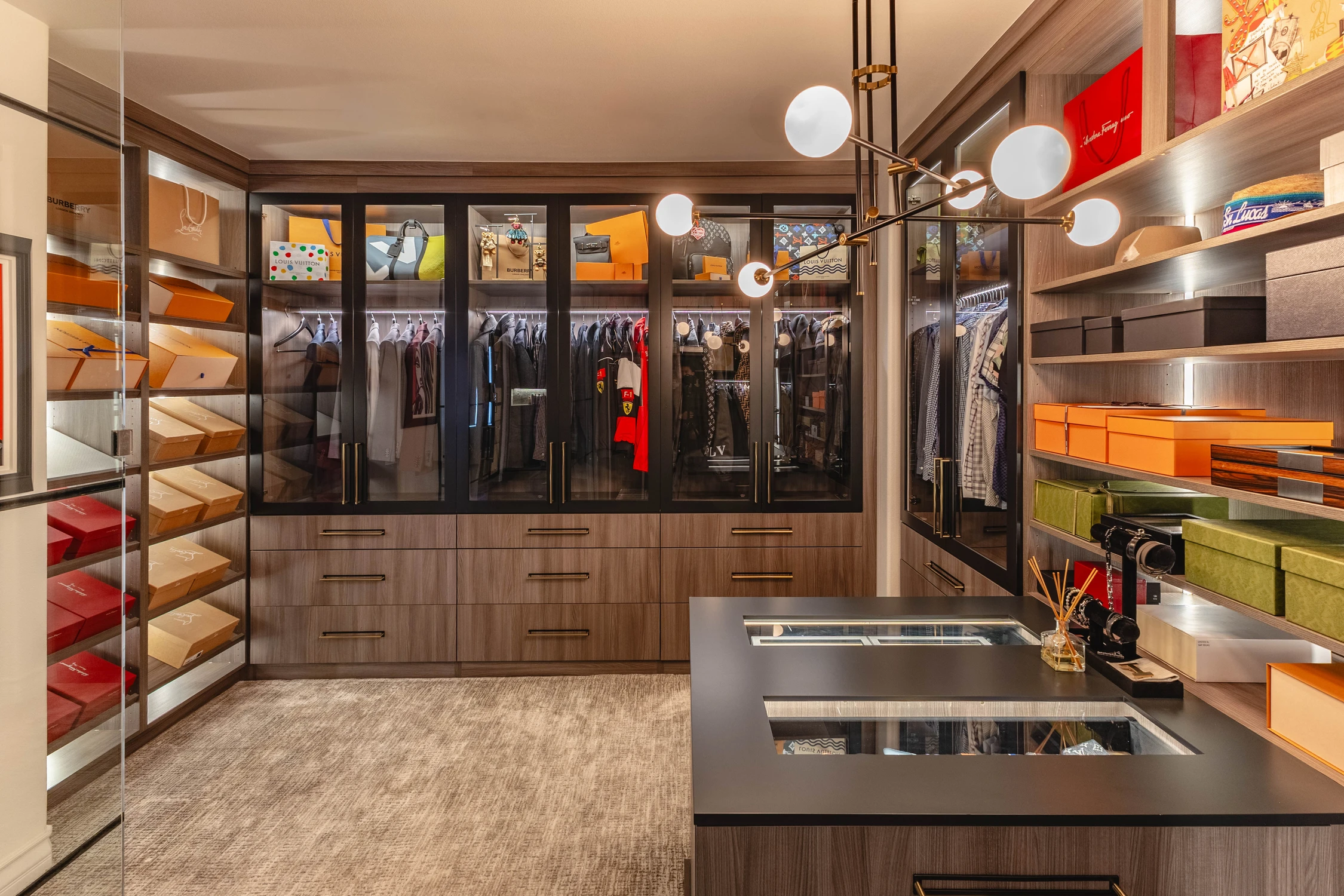 Walk-in closet with lit shelving and glass wardrobe doors