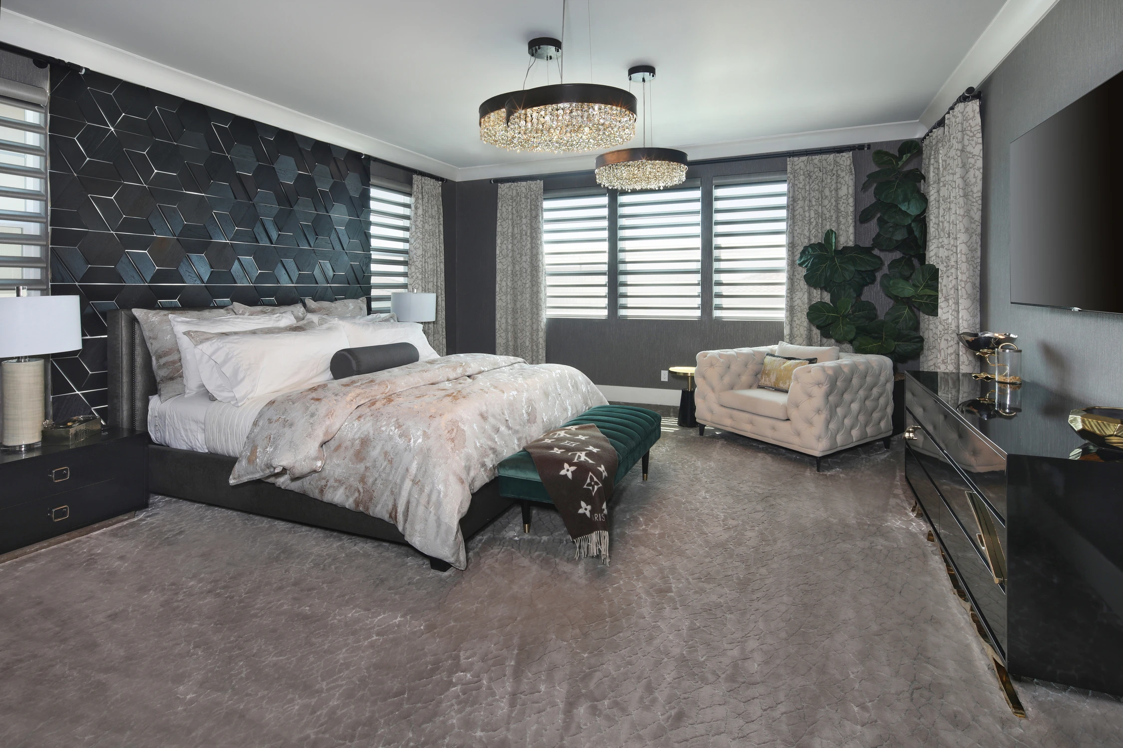 Bedroom with dark patterned wall and layered gray bedding