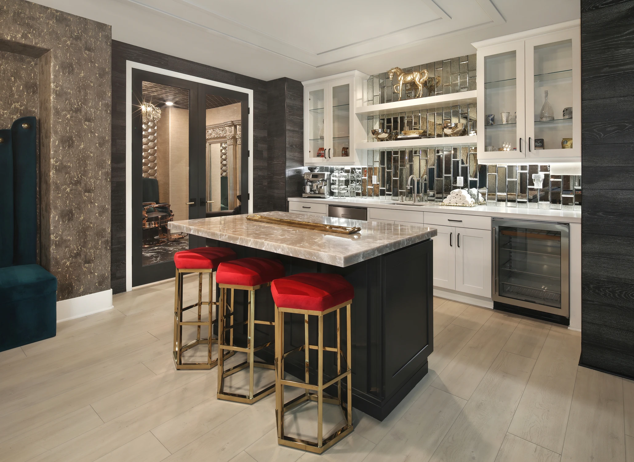 Kitchen with black island, mirrored bar cabinet, and red stools