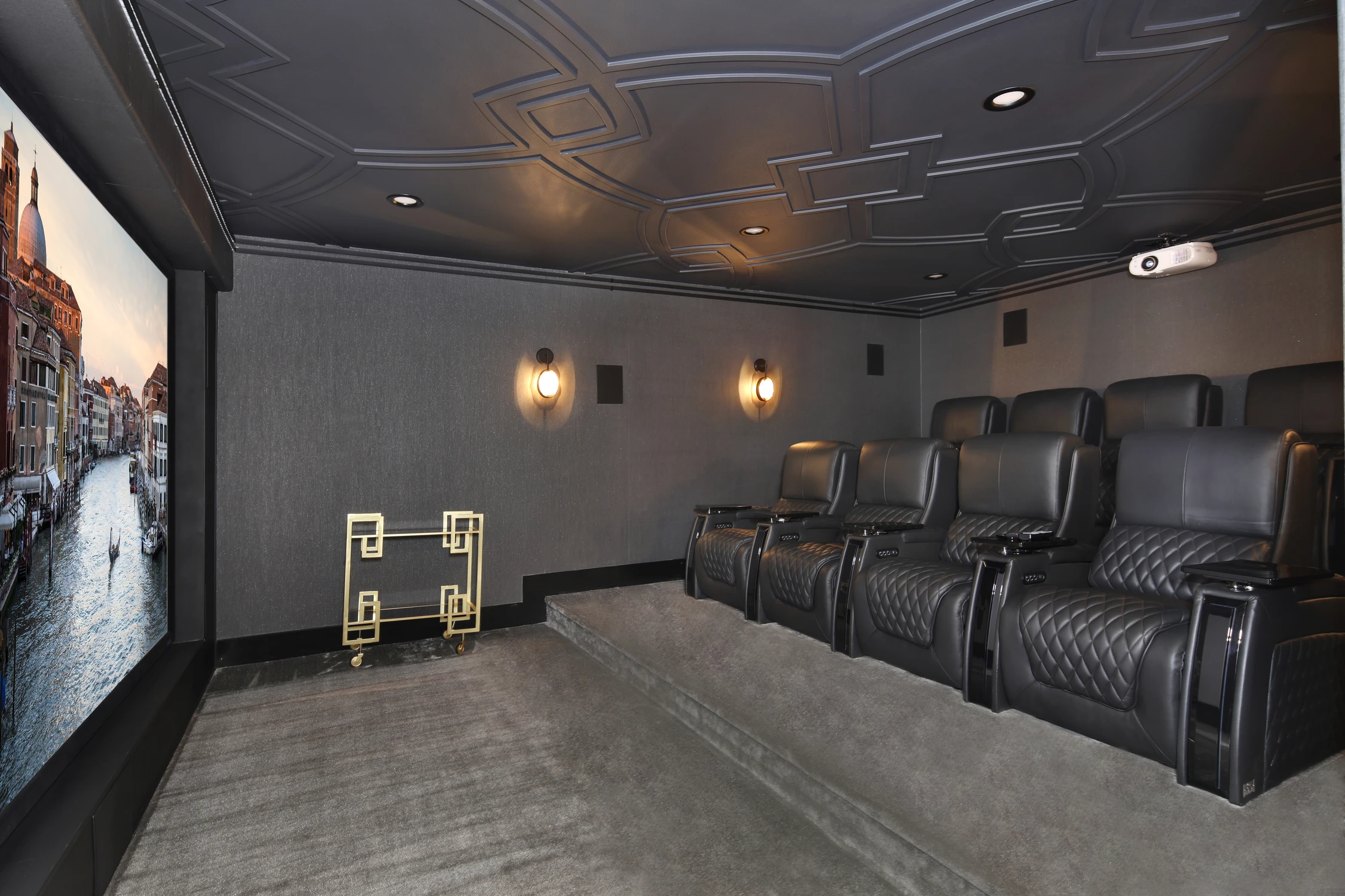 Home theater with black reclining seats and dark ceiling