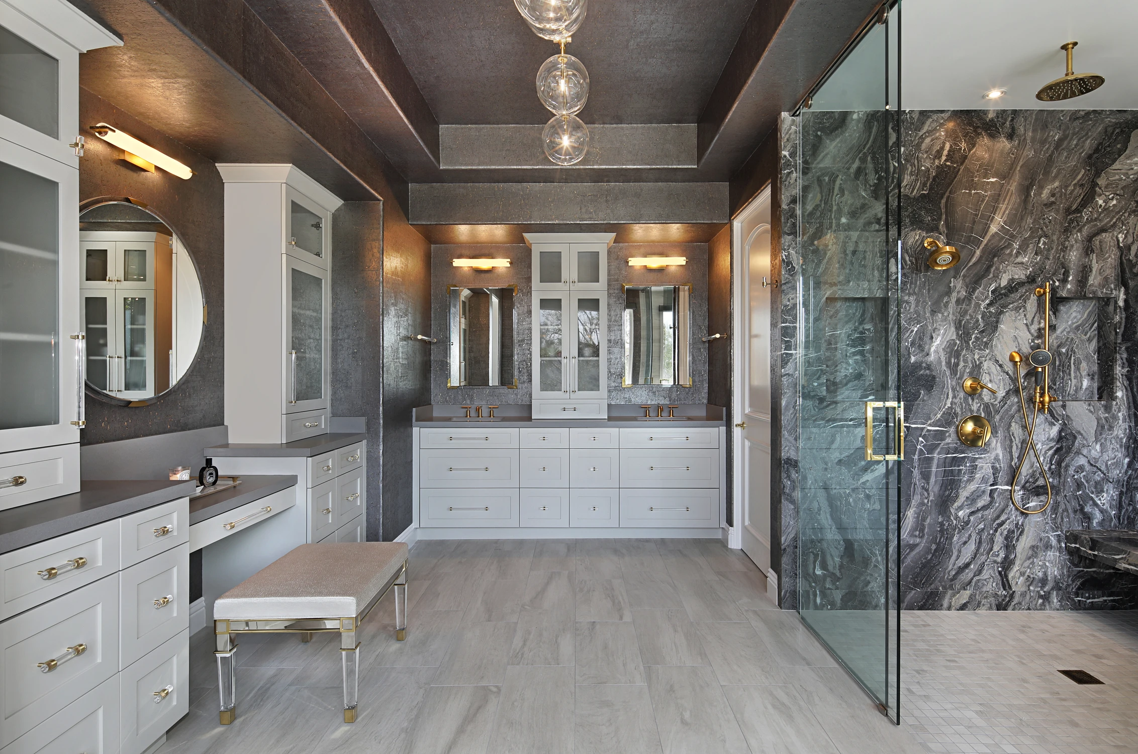 Bathroom with double vanity, dark walls, and stone shower
