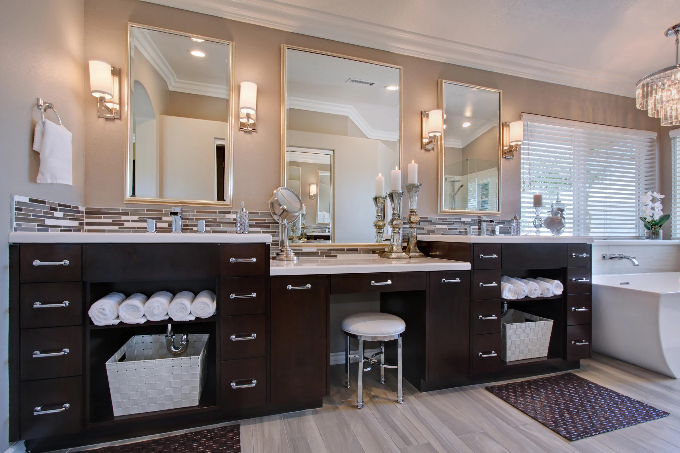 Bathroom vanity with twin framed mirrors and dark wood cabinetry