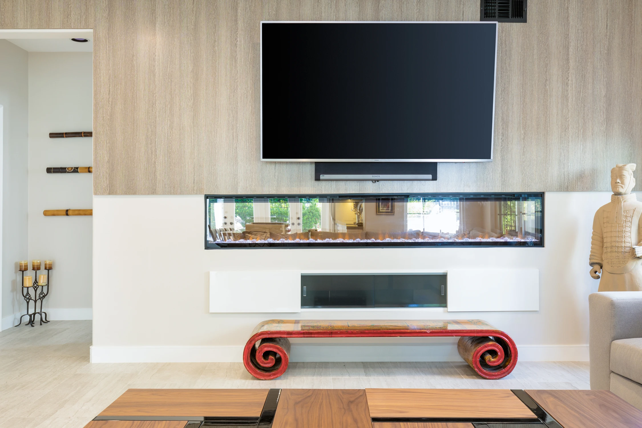Living room media wall with long linear fireplace and wood paneling