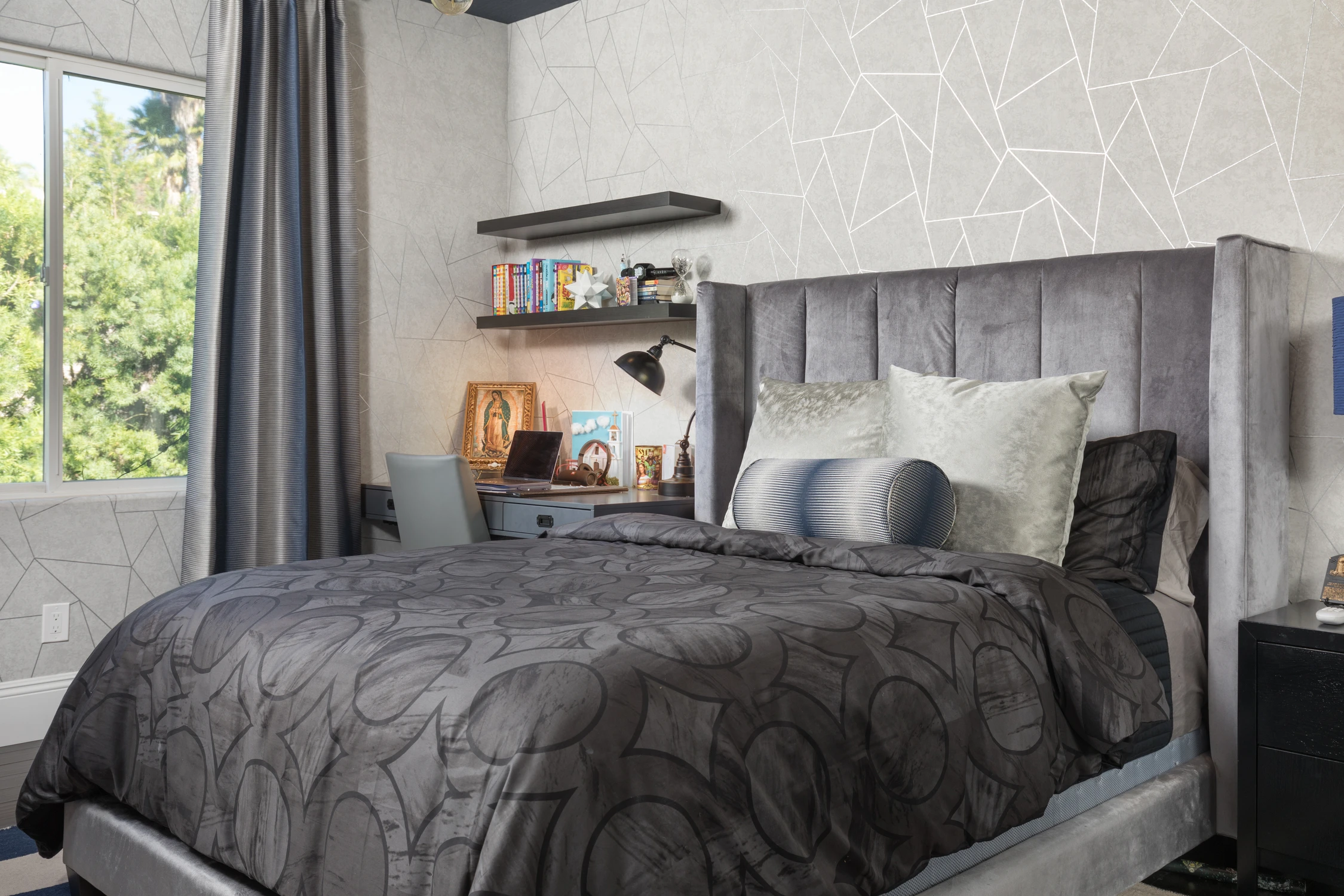 Bedroom with dark gray bed and floating shelf