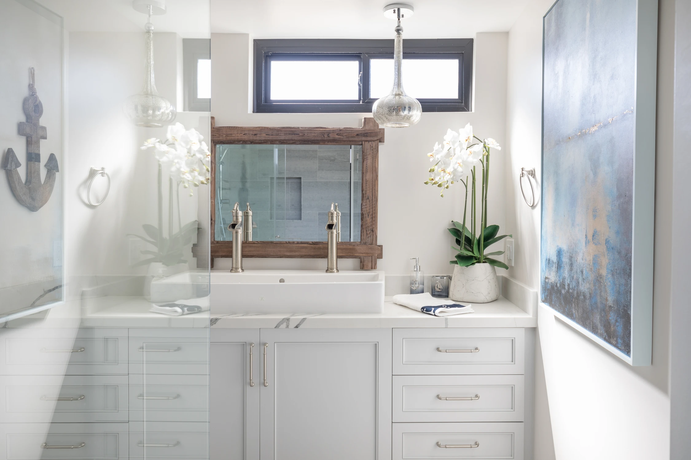 Bathroom vanity with weathered wood mirror frame and white cabinet