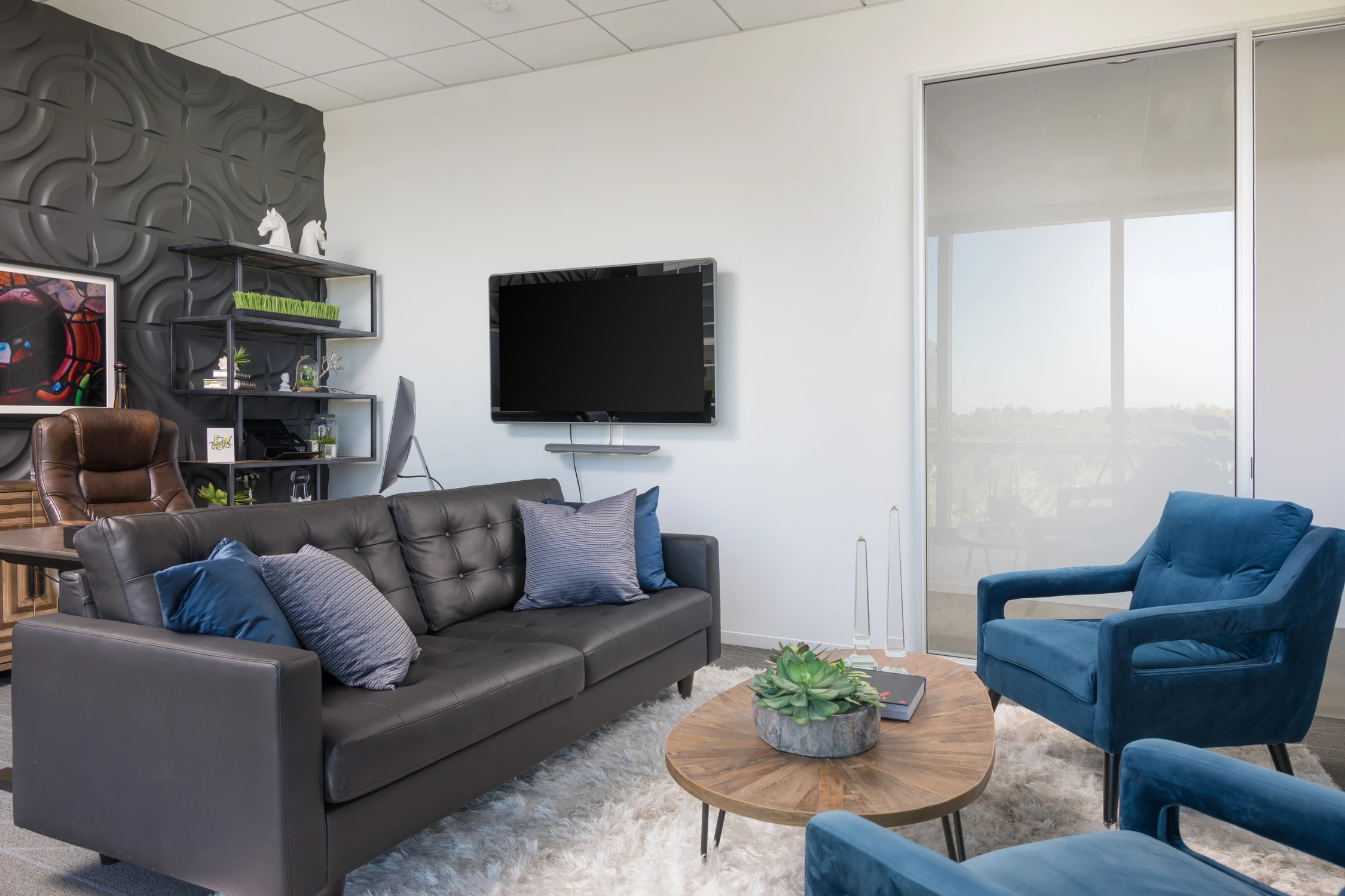 Close view of black sofa with blue accent pillows
