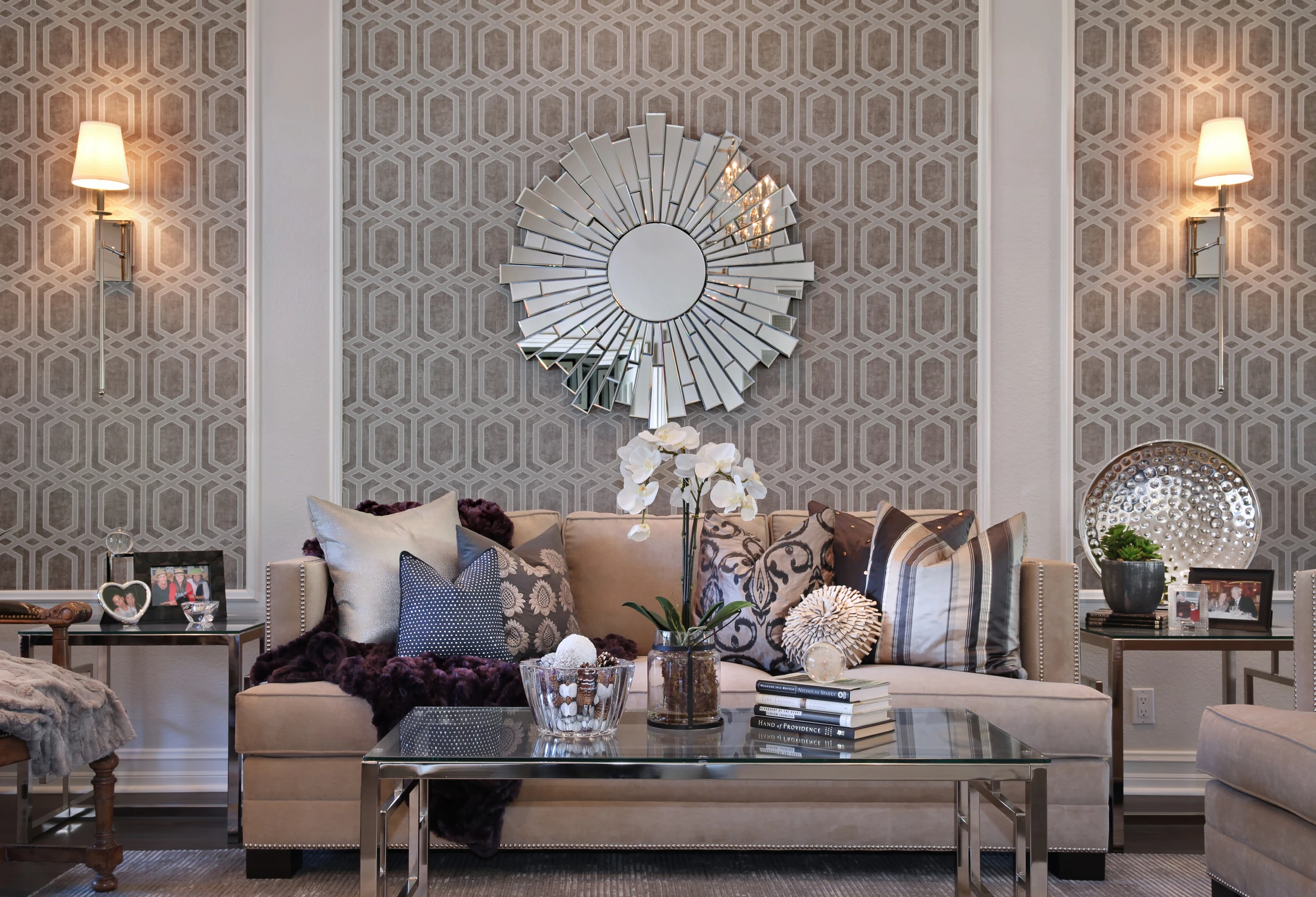 Formal living room with geometric wall panels, round mirror, and neutral sofa