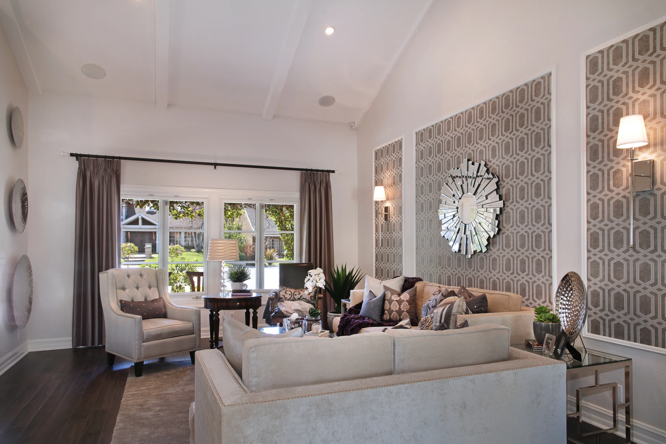 Living room with pale sofa facing garden doors and patterned feature wall