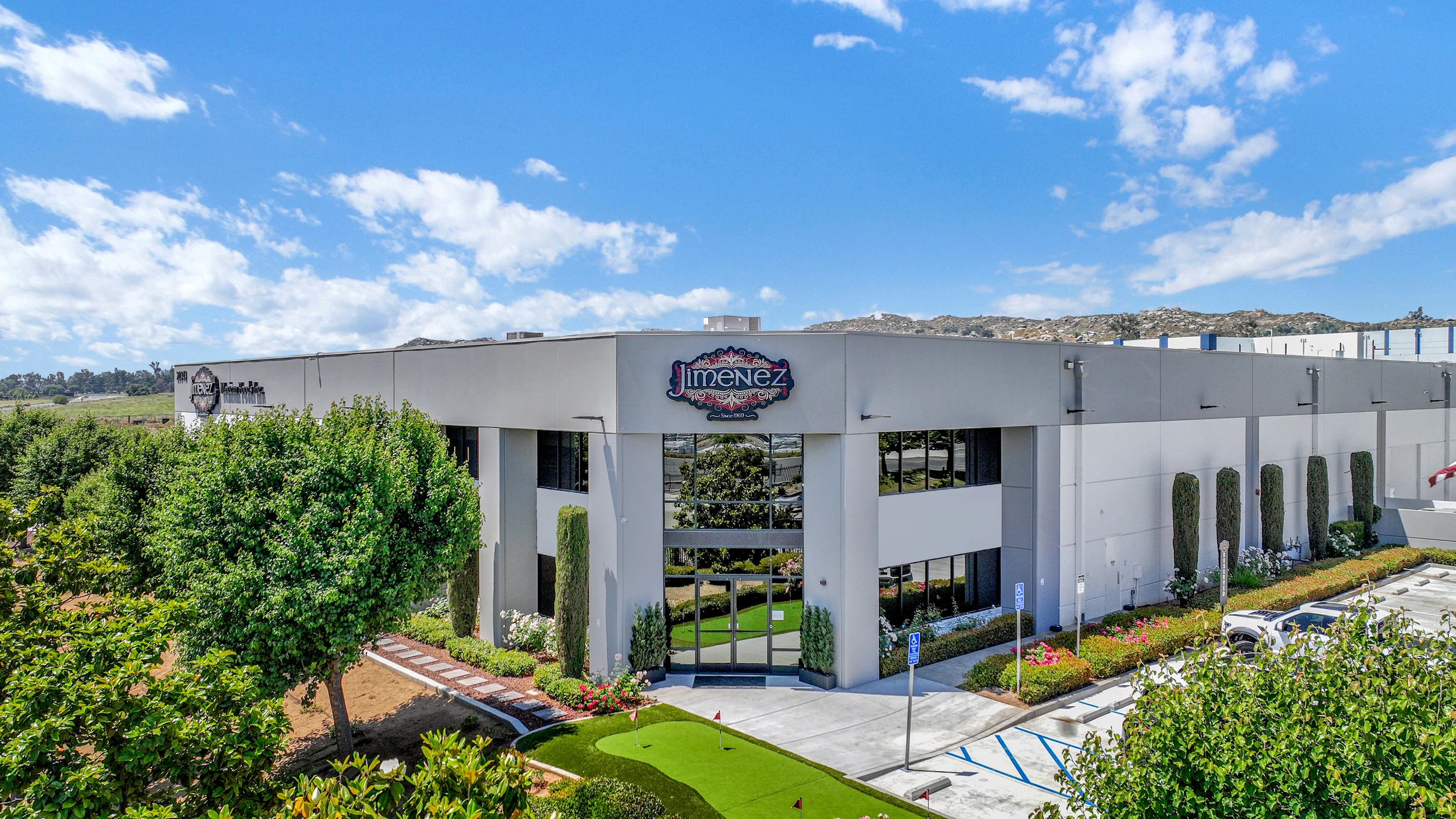 Commercial building with landscaped entry and white facade