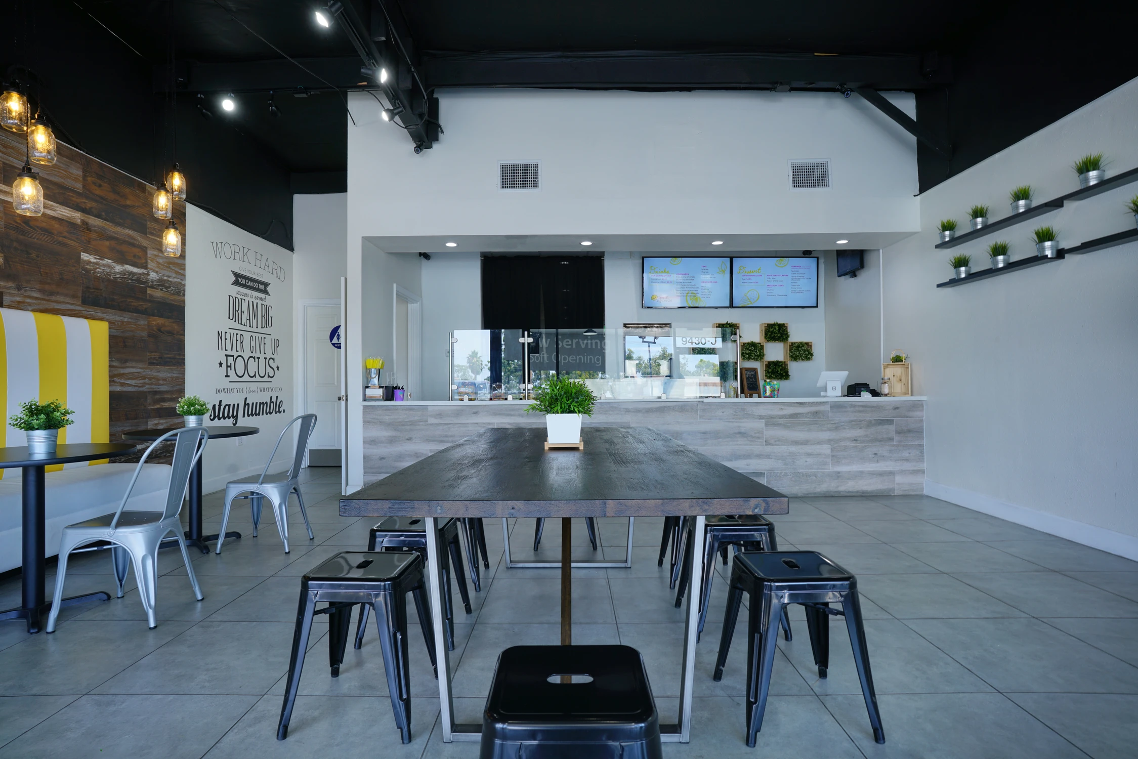 Communal table facing service counter in bright food retail interior
