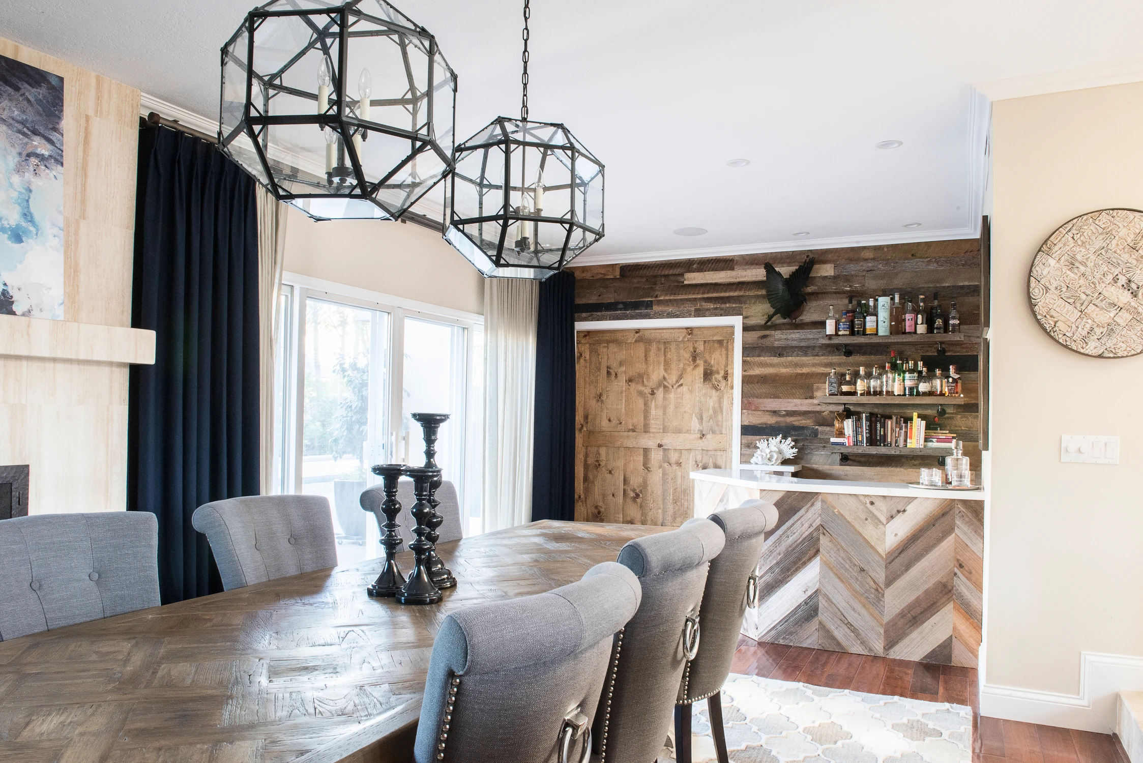 Dining table with pale runner, gray chairs, and dark wood wall