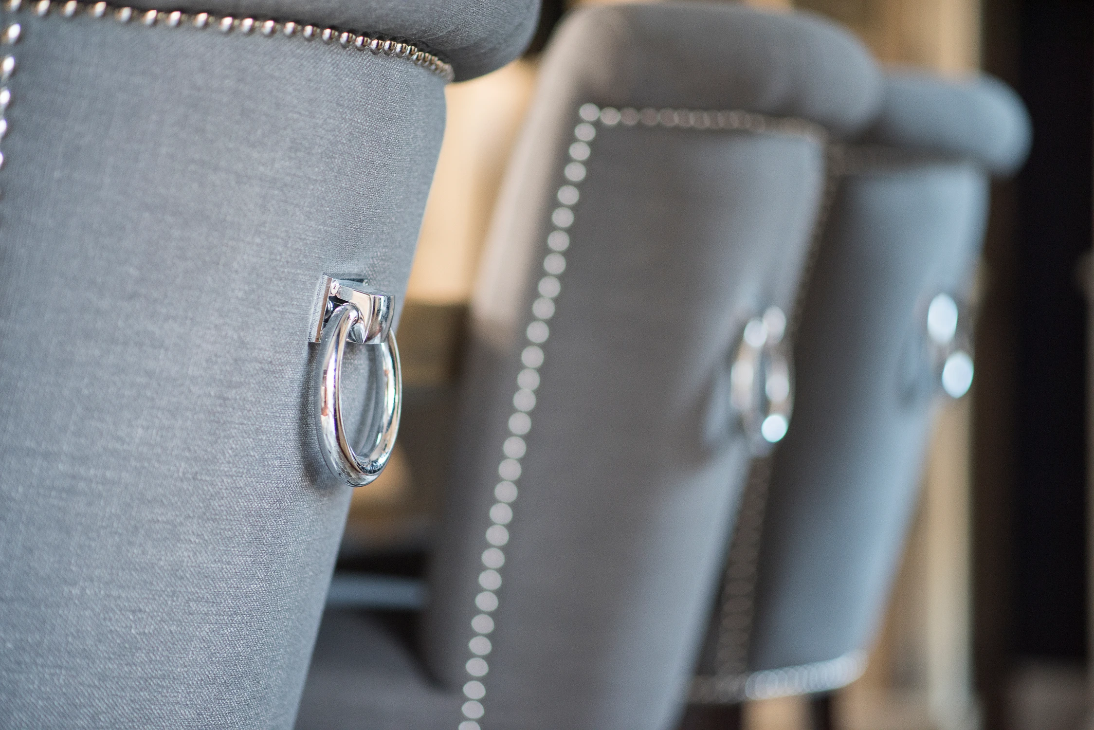 Close view of gray dining chairs with ring pulls