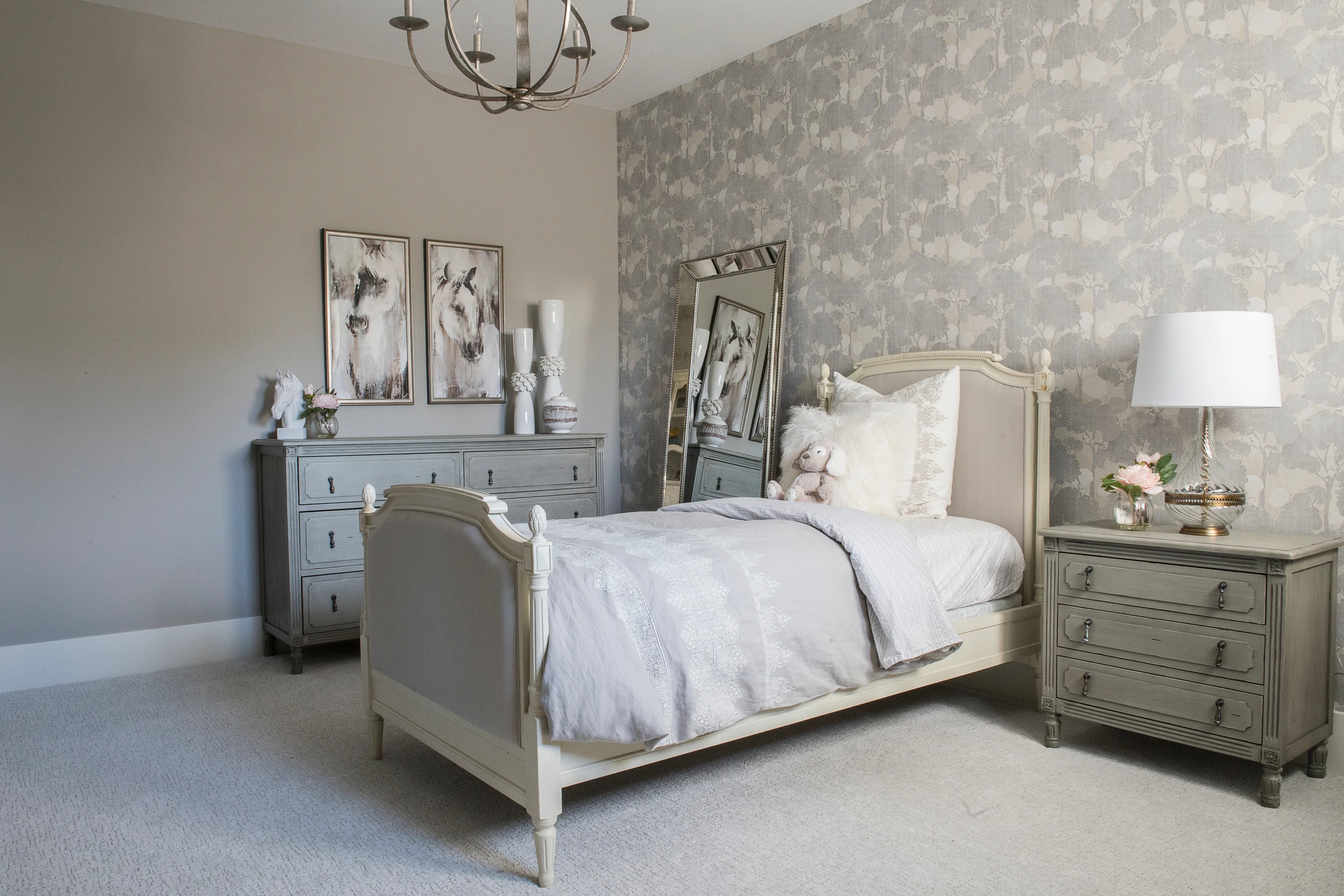 Bedroom with mirrored dresser, white bedding, and soft gray walls