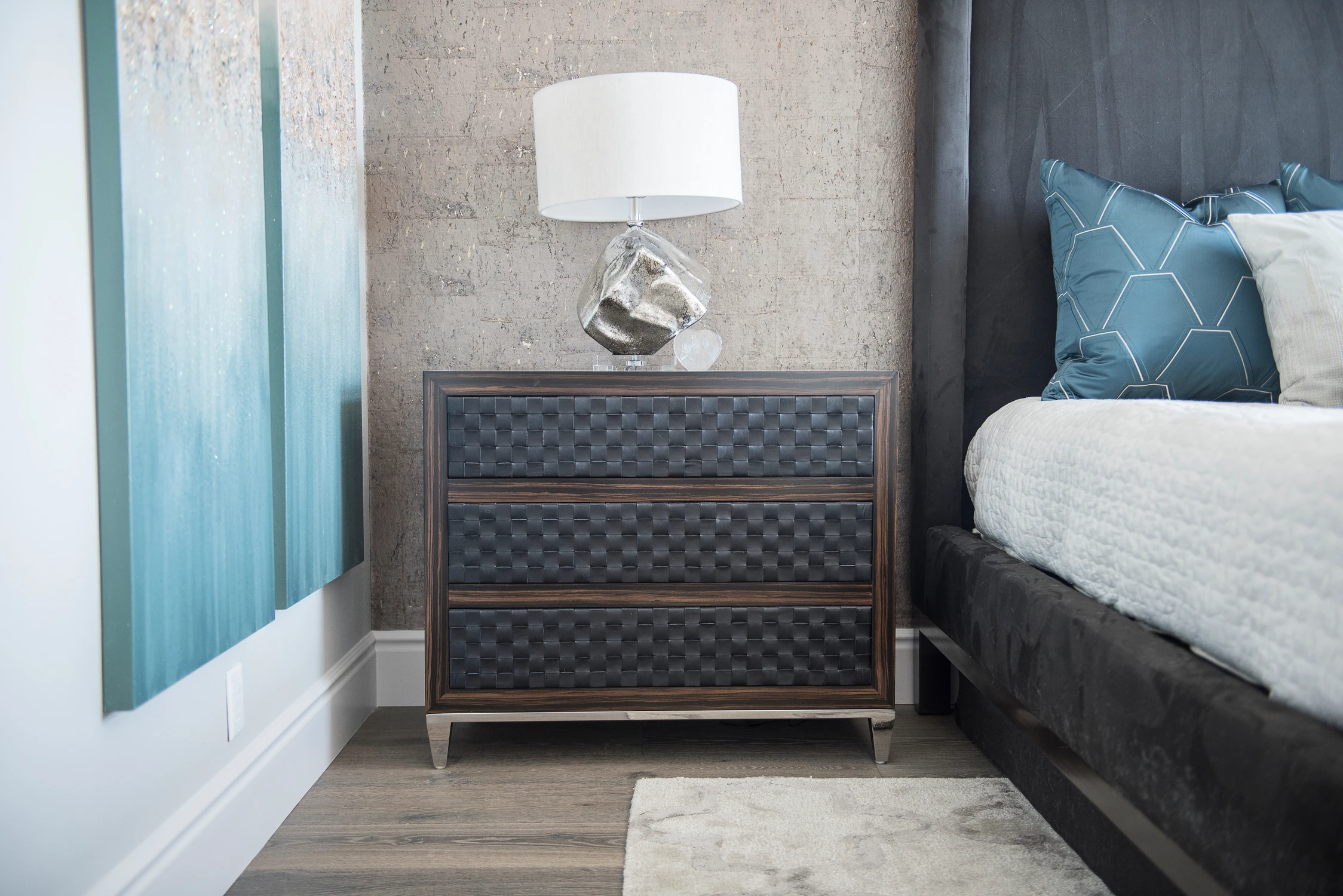 Bedroom close view with dark upholstered headboard and white bedding
