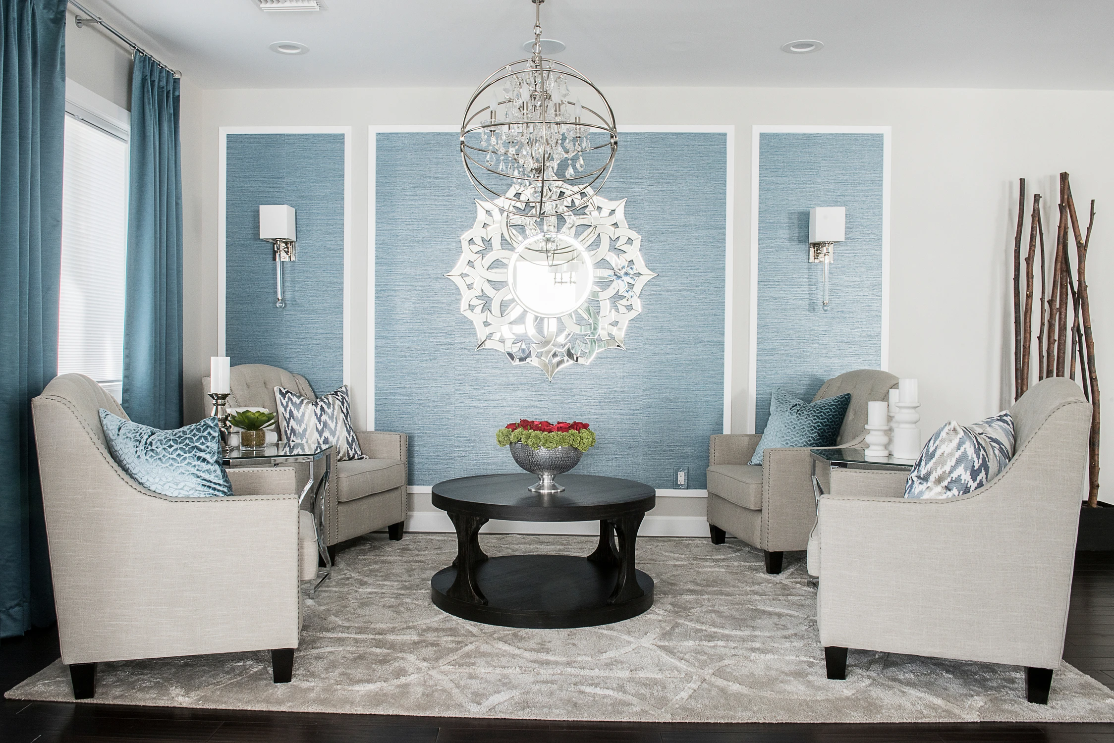 Blue-accent sitting room with white chairs and round coffee table