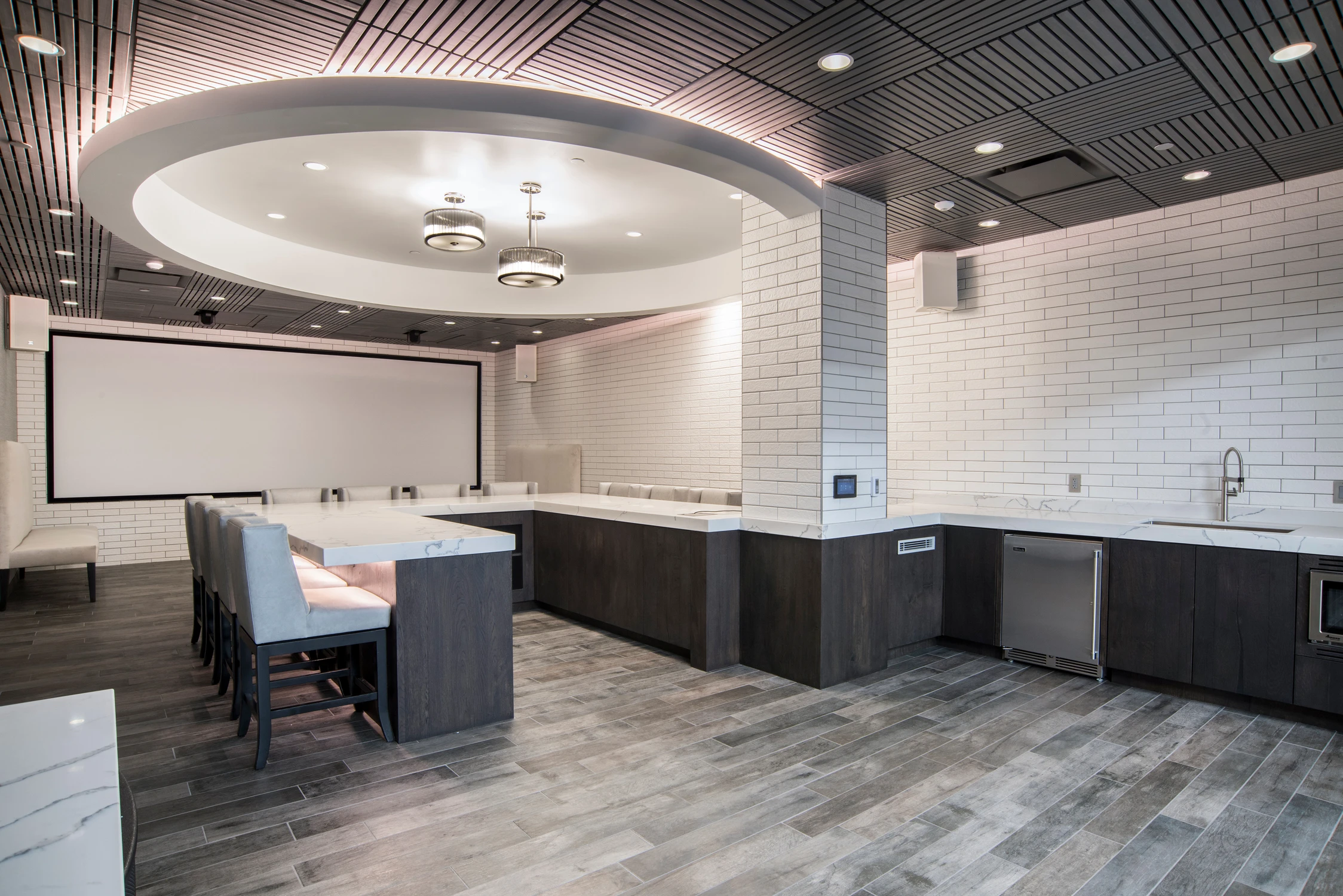 Food tasting room with circular ceiling detail and central communal table