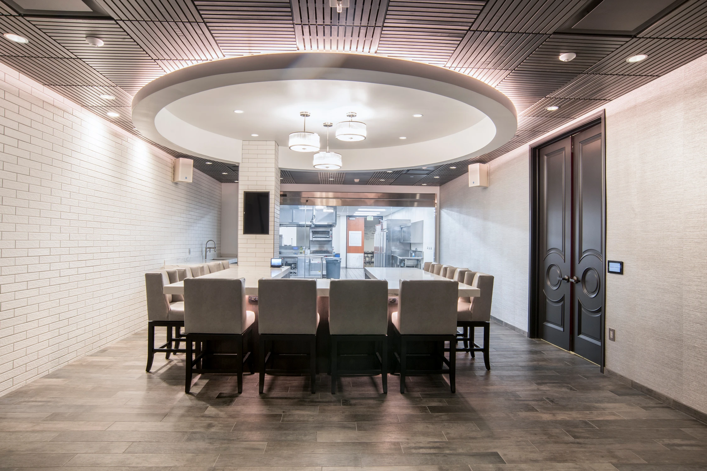Dining table facing glass entry within the food tasting room