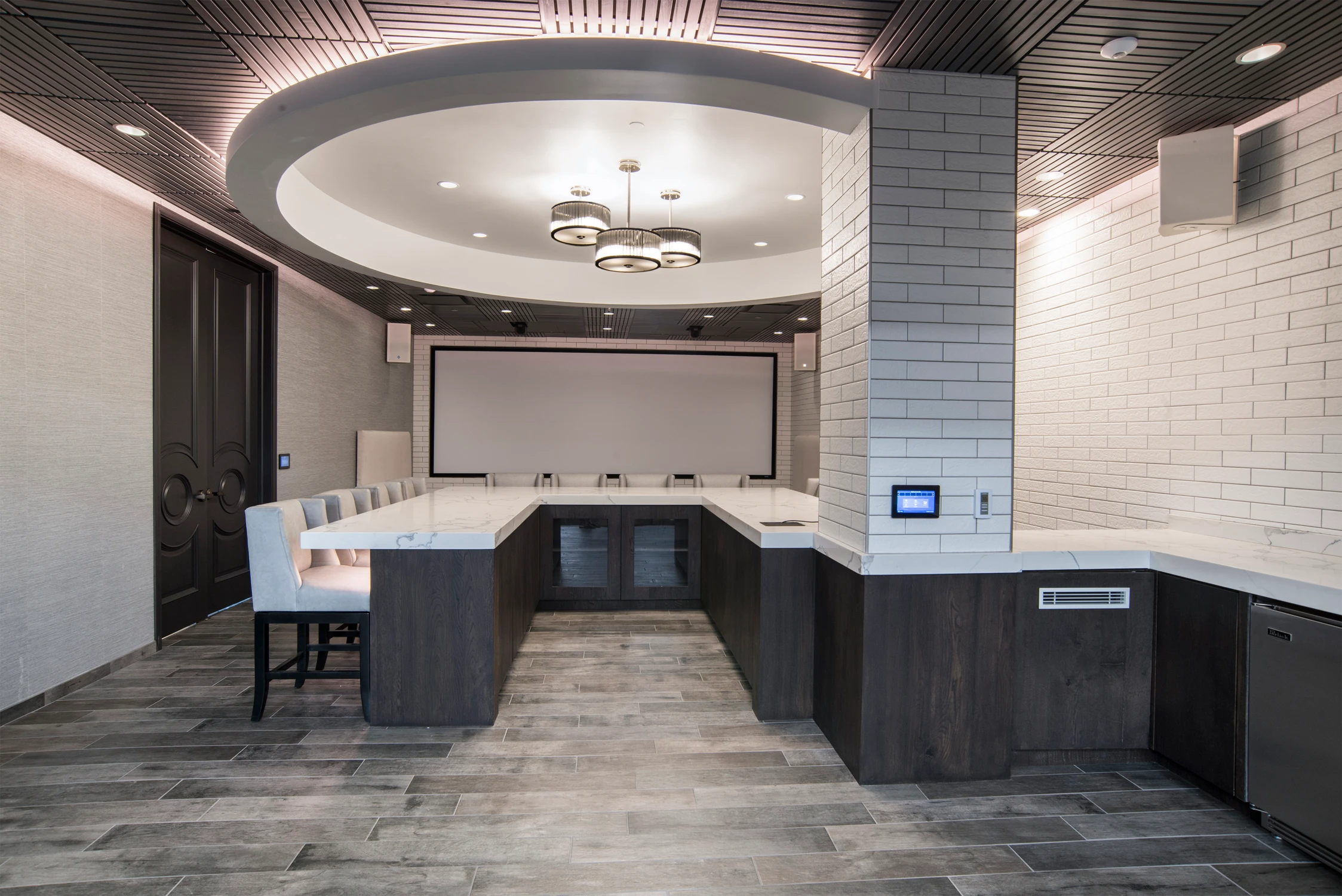 Commercial tasting room with curved ceiling lighting and U-shaped counter