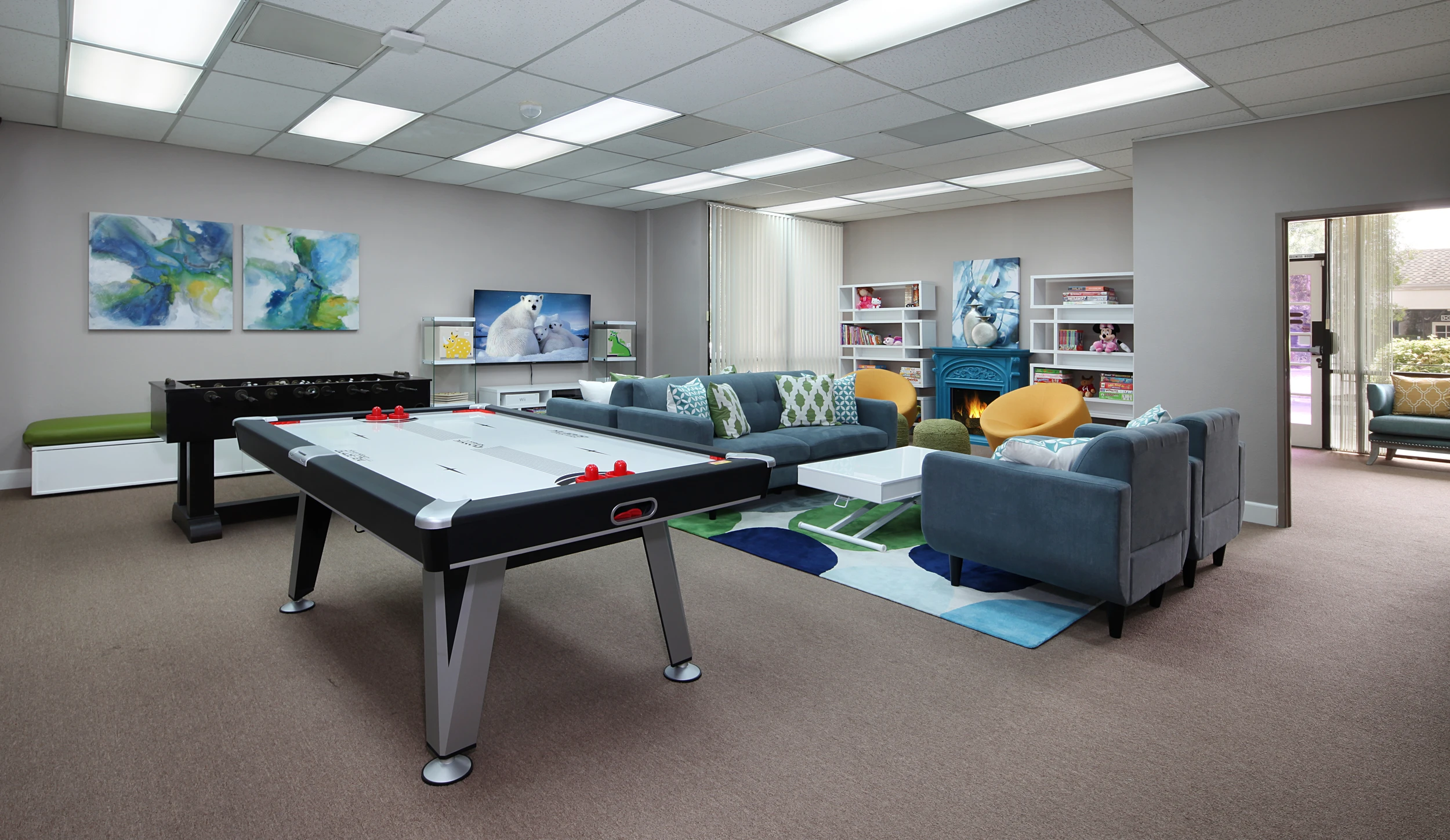 Game table and blue lounge seating in child therapy room