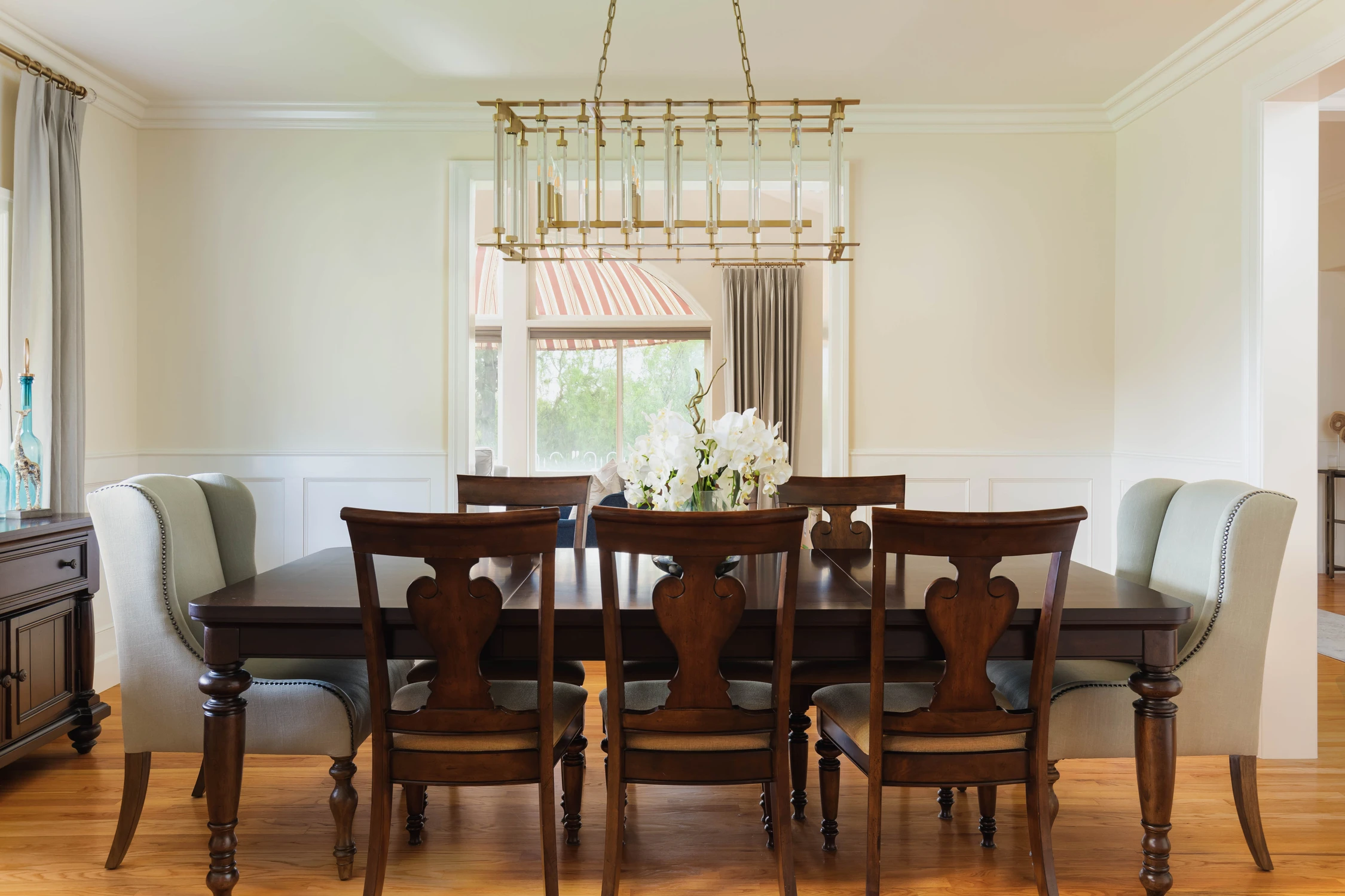 Formal dining room with dark wood table and geometric chandelier