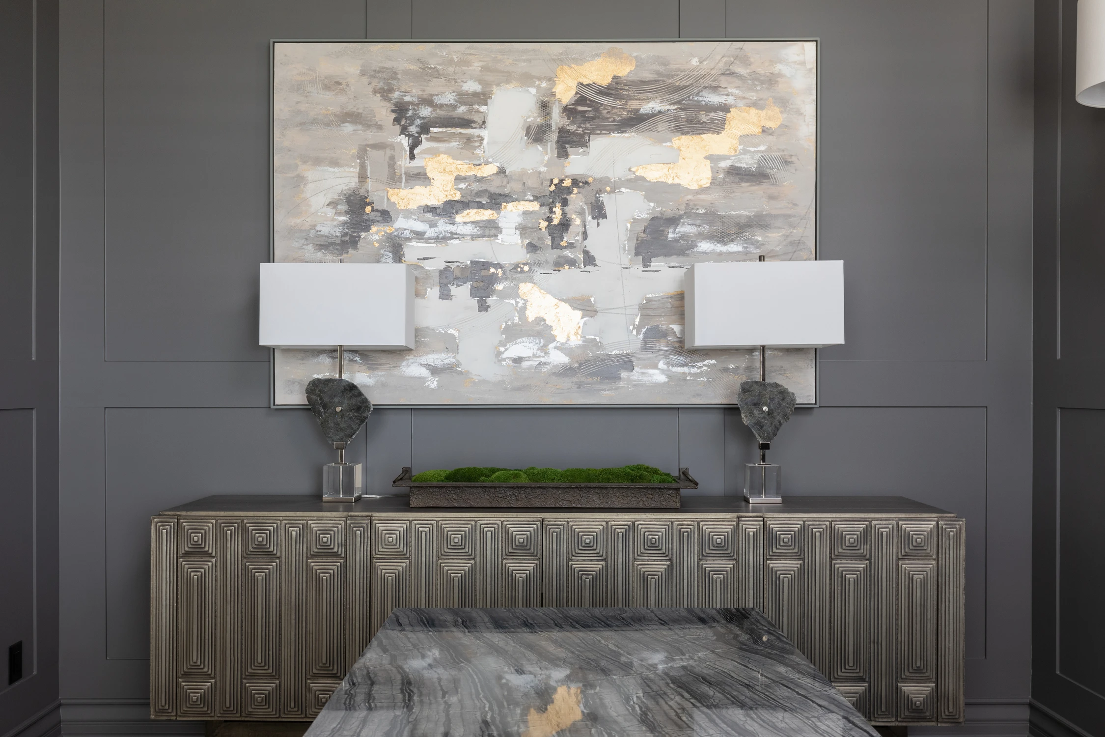 Textured sideboard beneath a large abstract painting in the home office