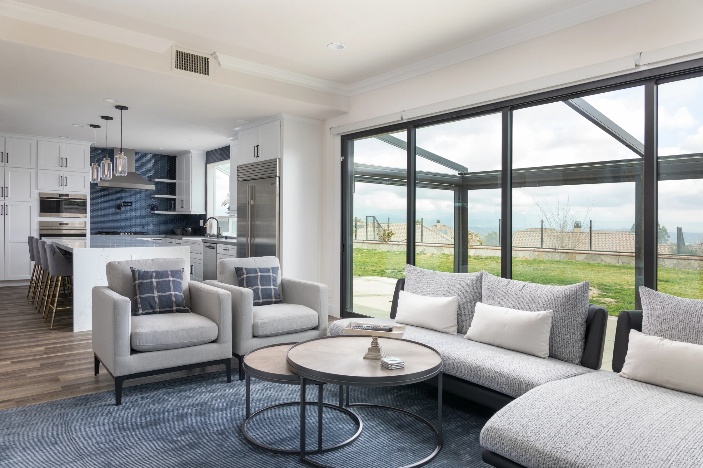 Open kitchen and family room beside folding glass doors